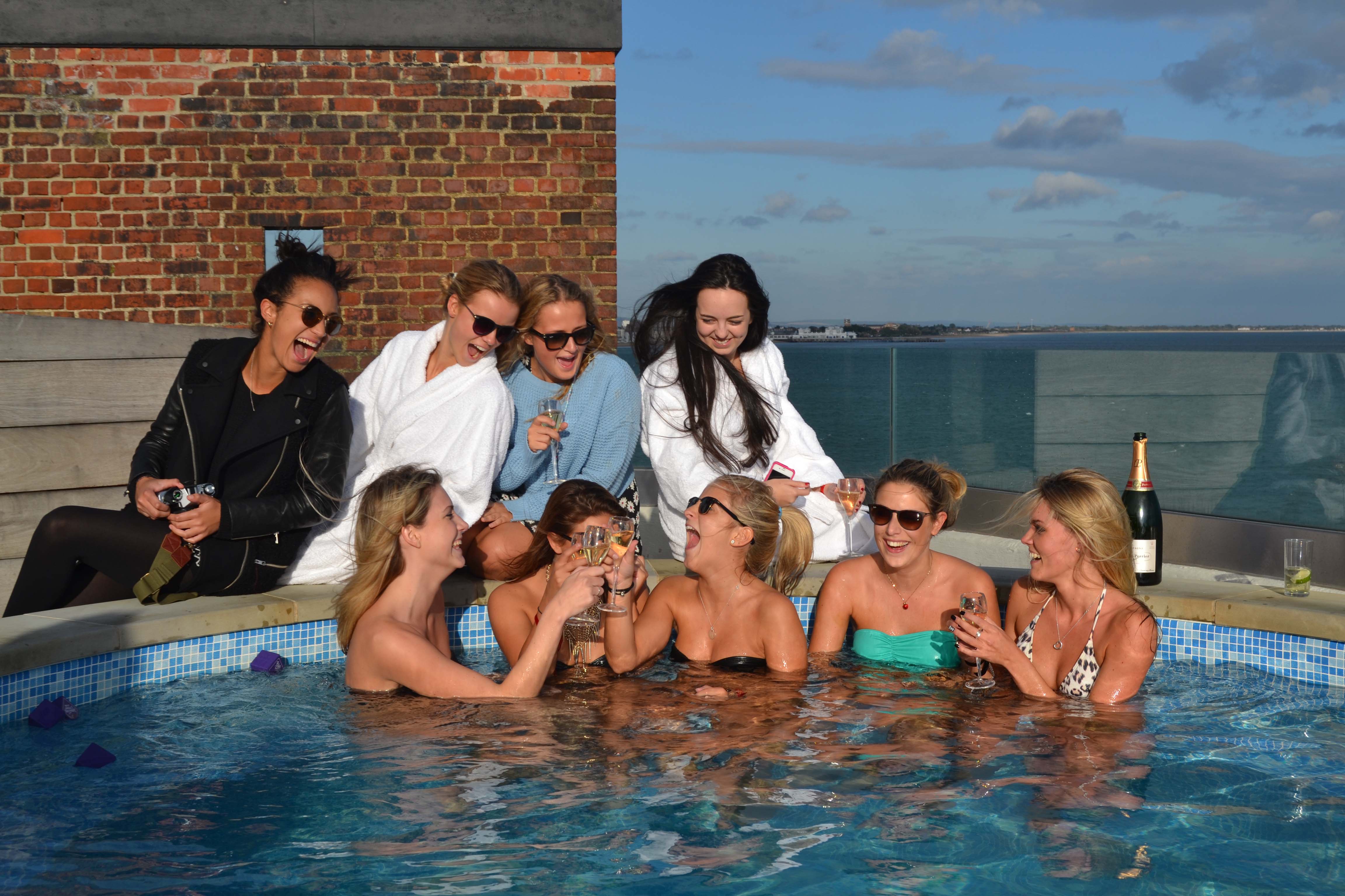 Rooftop pool party at No Man's Fort with women celebrating and networking.