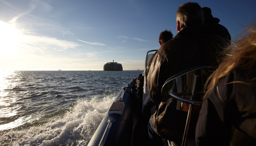 Group on boat approaching No Man's Fort for team-building retreat.