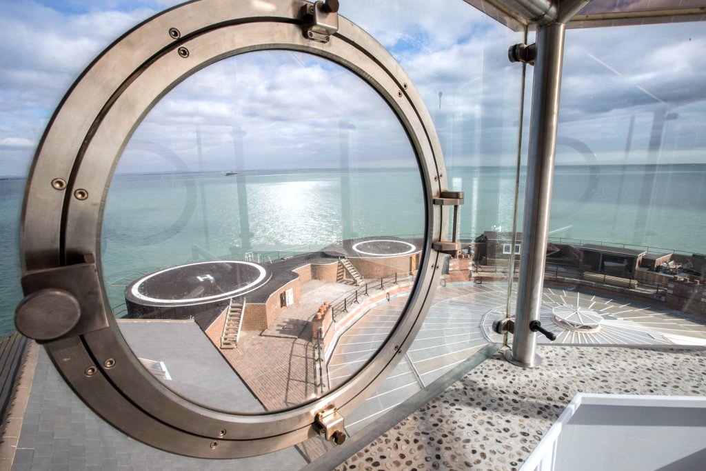 Boardroom in No Man's Fort with circular window, ideal for meetings and retreats.