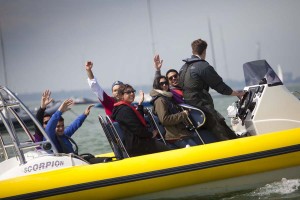 Group enjoying a boat ride at No Man's Fort during a corporate retreat.