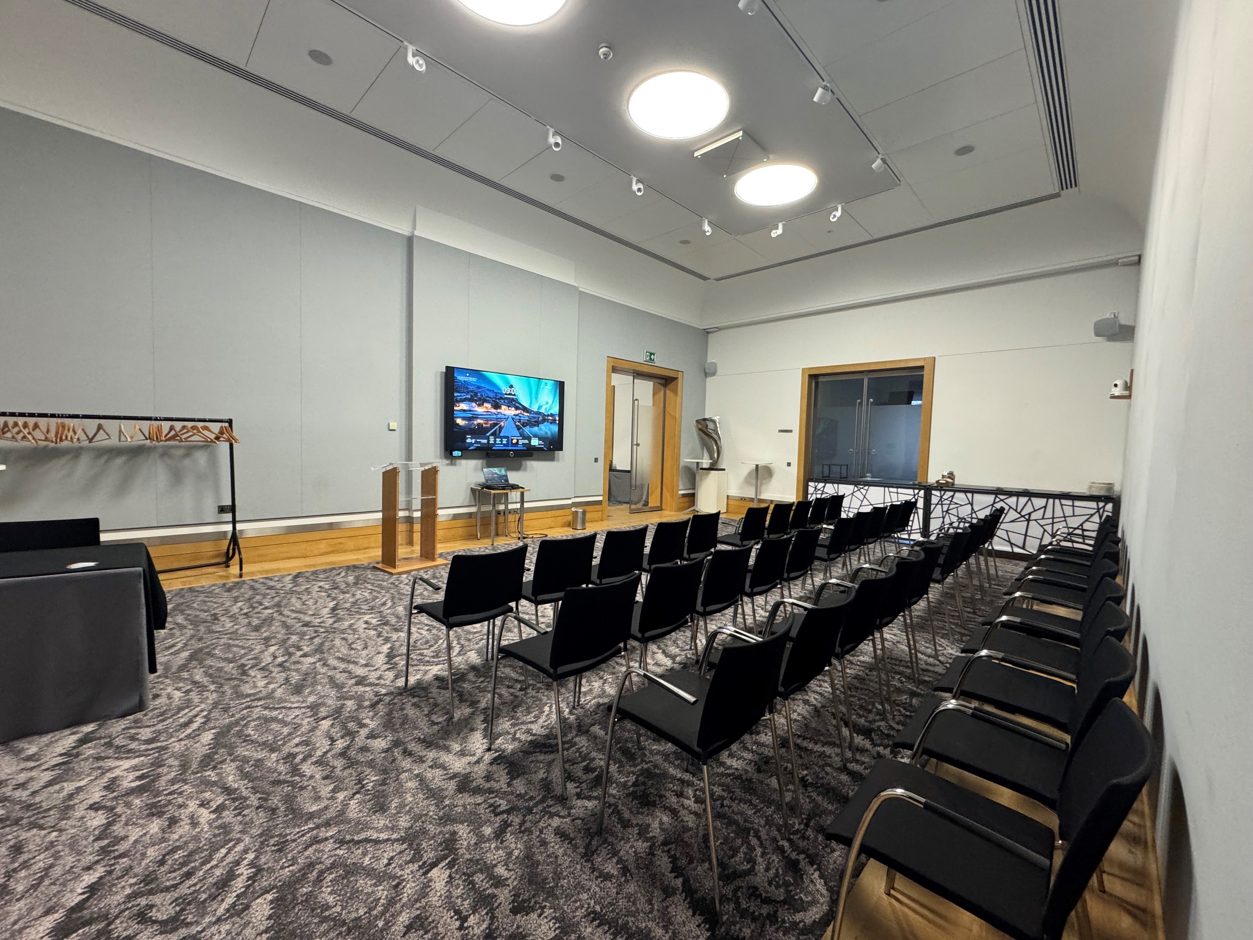 Rolls Royce meeting room with black chairs, ideal for professional workshops and presentations.
