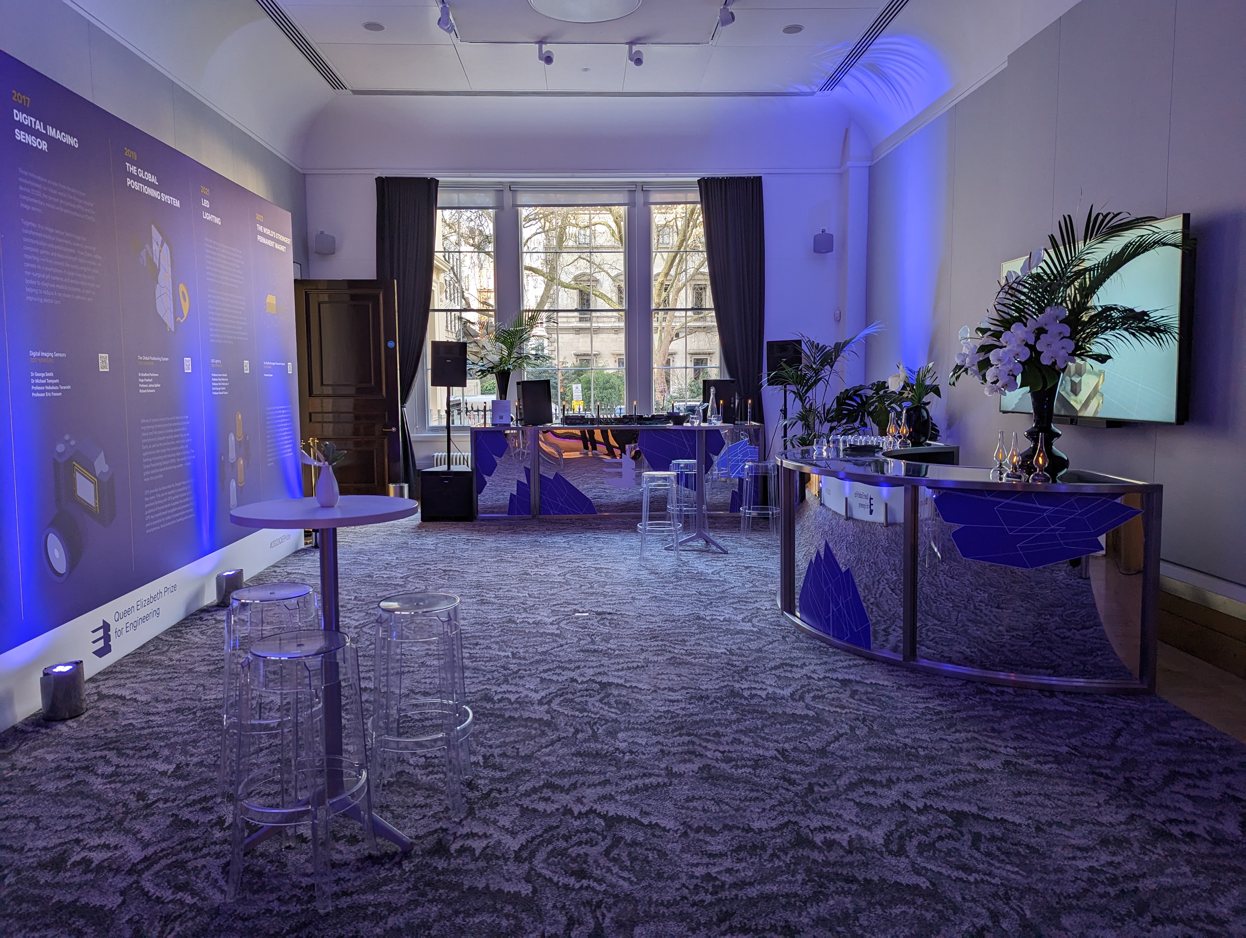 Rolls Royce in elegant event space with blue lighting for networking and presentations.
