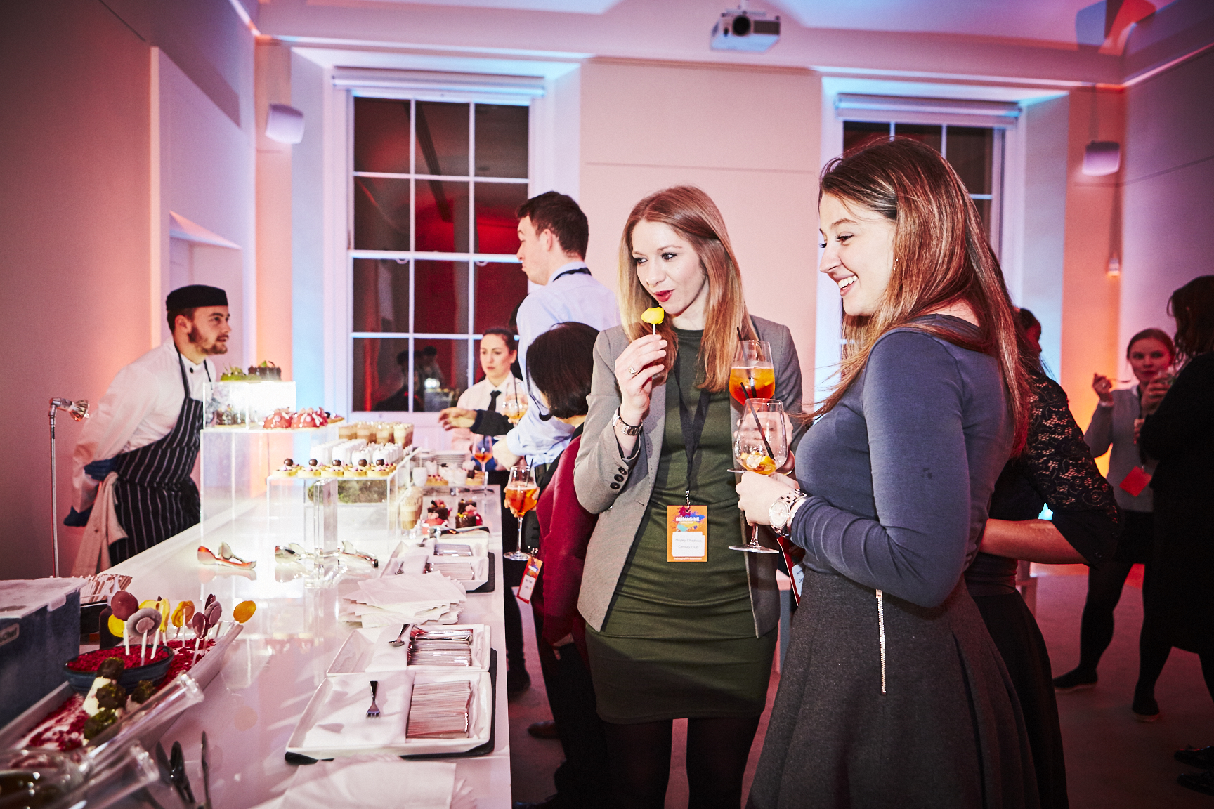 Rolls Royce at a vibrant networking event with elegant hors d'oeuvres and drinks.