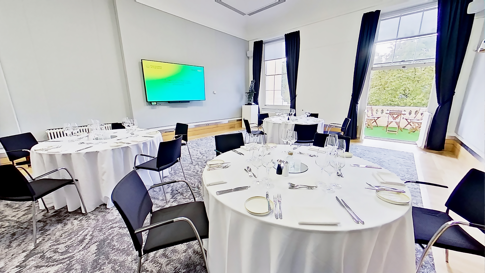 Rolls Royce meeting room with elegant tables, ideal for events and presentations.