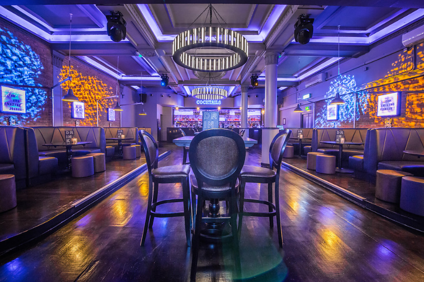 Stylish cocktail bar in Sway with vibrant lighting for events and gatherings.