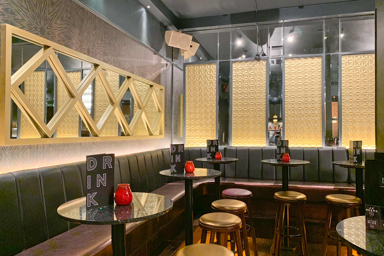 Stylish event space with sleek black furniture for cocktail receptions and gatherings.