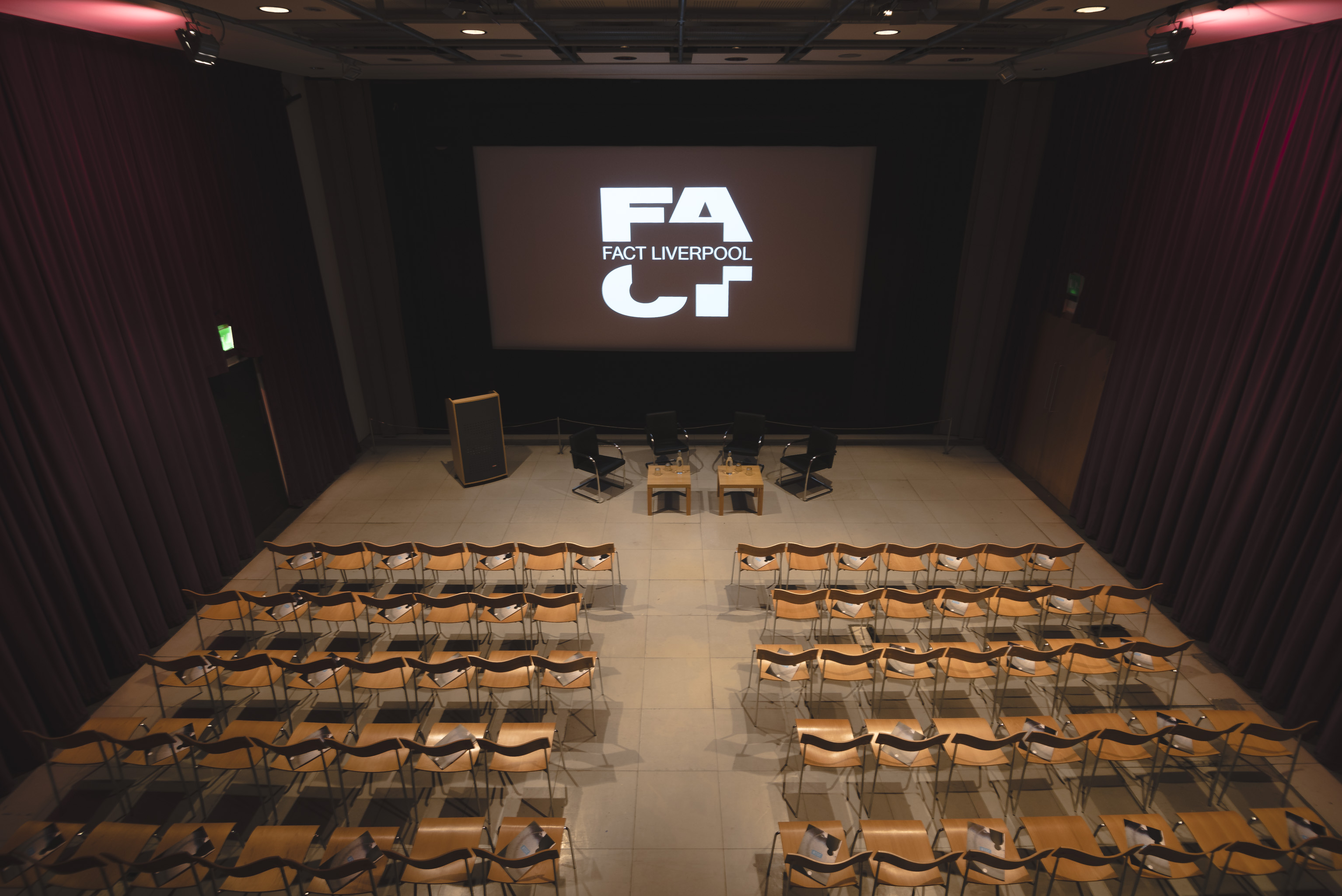 Event space at FACT Liverpool with a large screen for presentations and panel discussions.