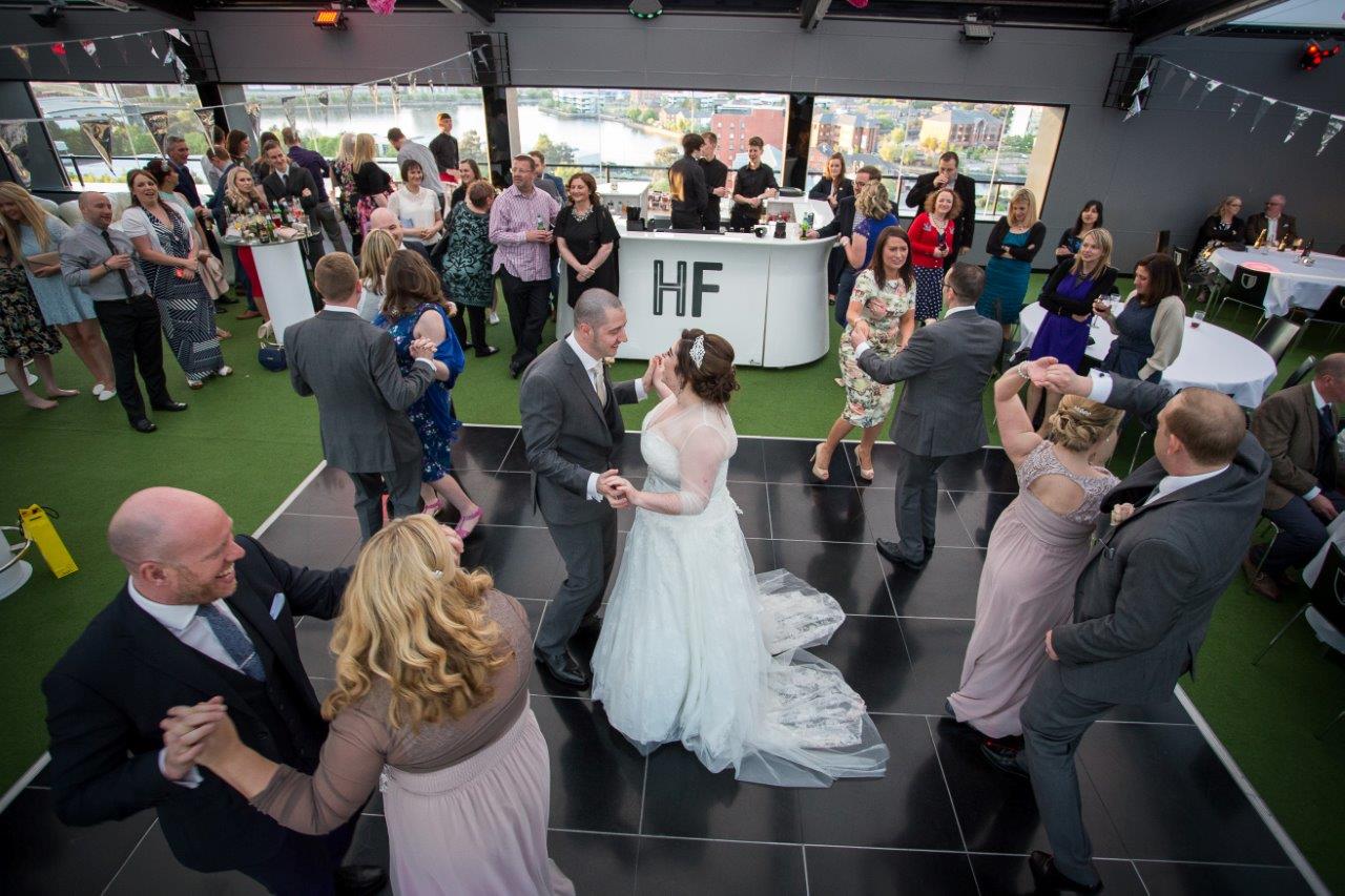 Vibrant wedding reception at Hotel Football with lively dance floor and modern decor.