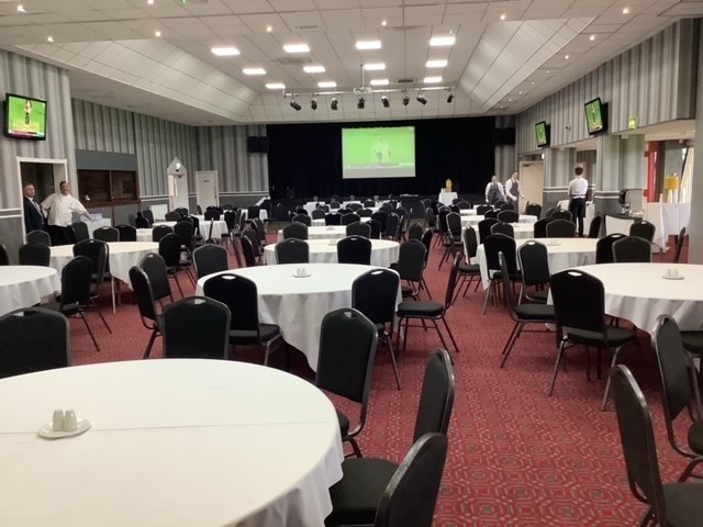 Spacious Walsall FC event venue with round tables, ideal for meetings and banquets.
