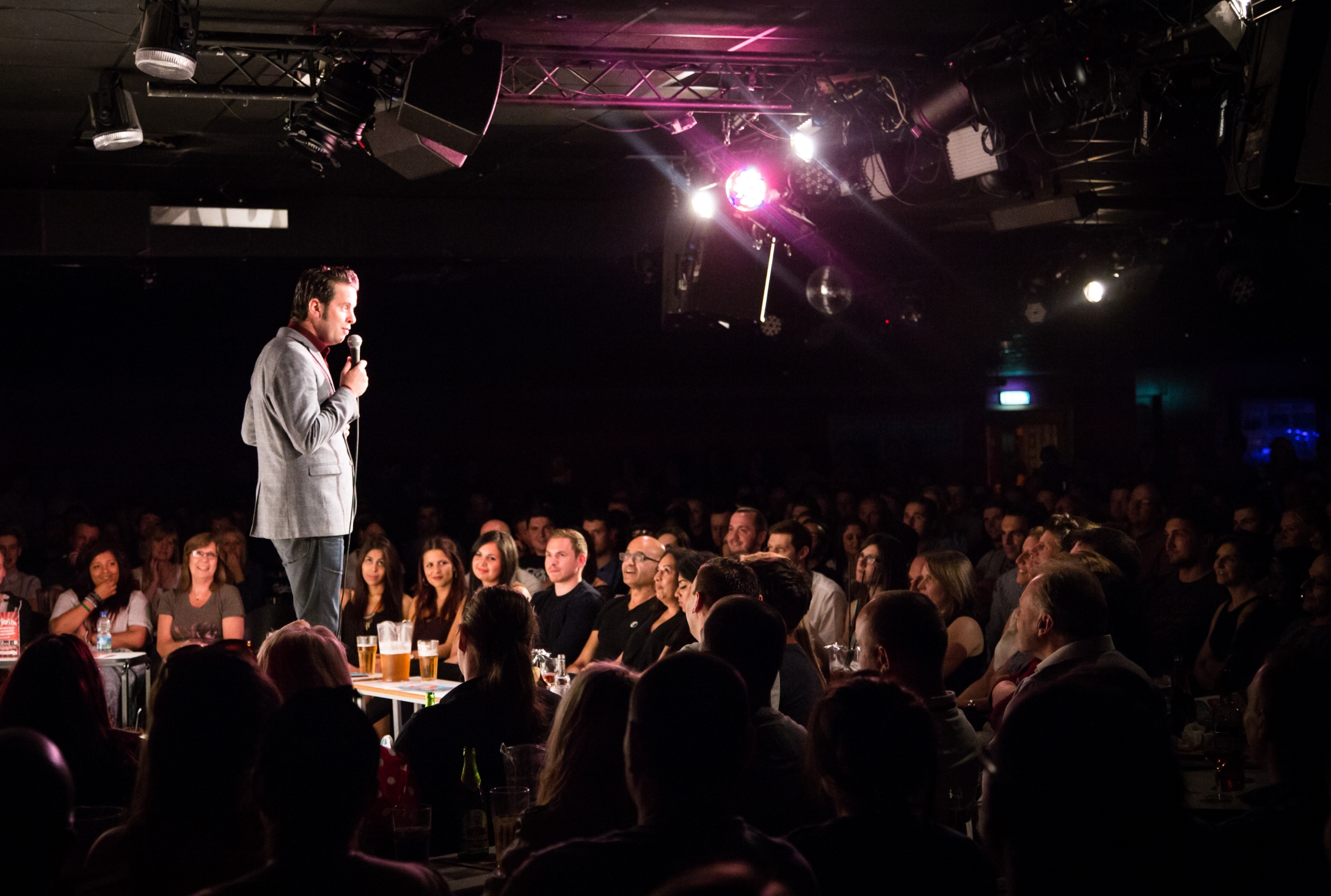 Lively comedy event in Glee Club Birmingham with engaging performer and vibrant atmosphere.