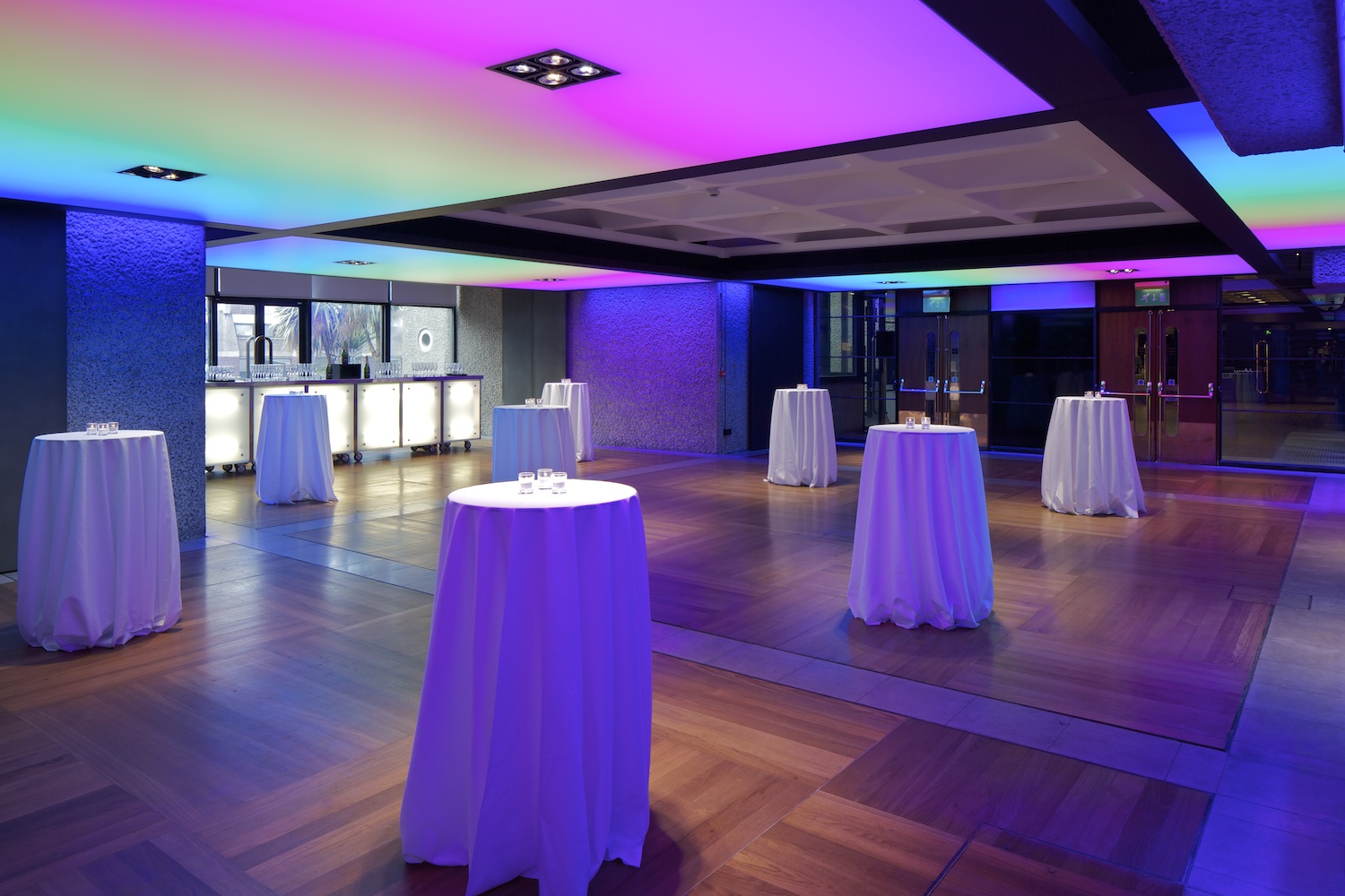 Modern event space at Barbican Centre with elegant high-top tables for cocktail receptions.