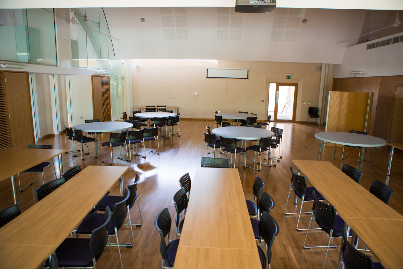 Versatile event space at St Barnabas Church Centre with natural light and polished wood floor.