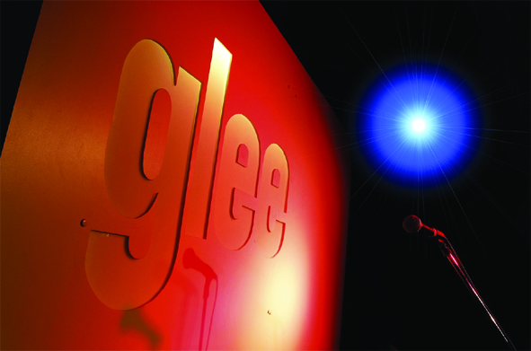 Vibrant "glee" stage backdrop in Birmingham for live performances and events.