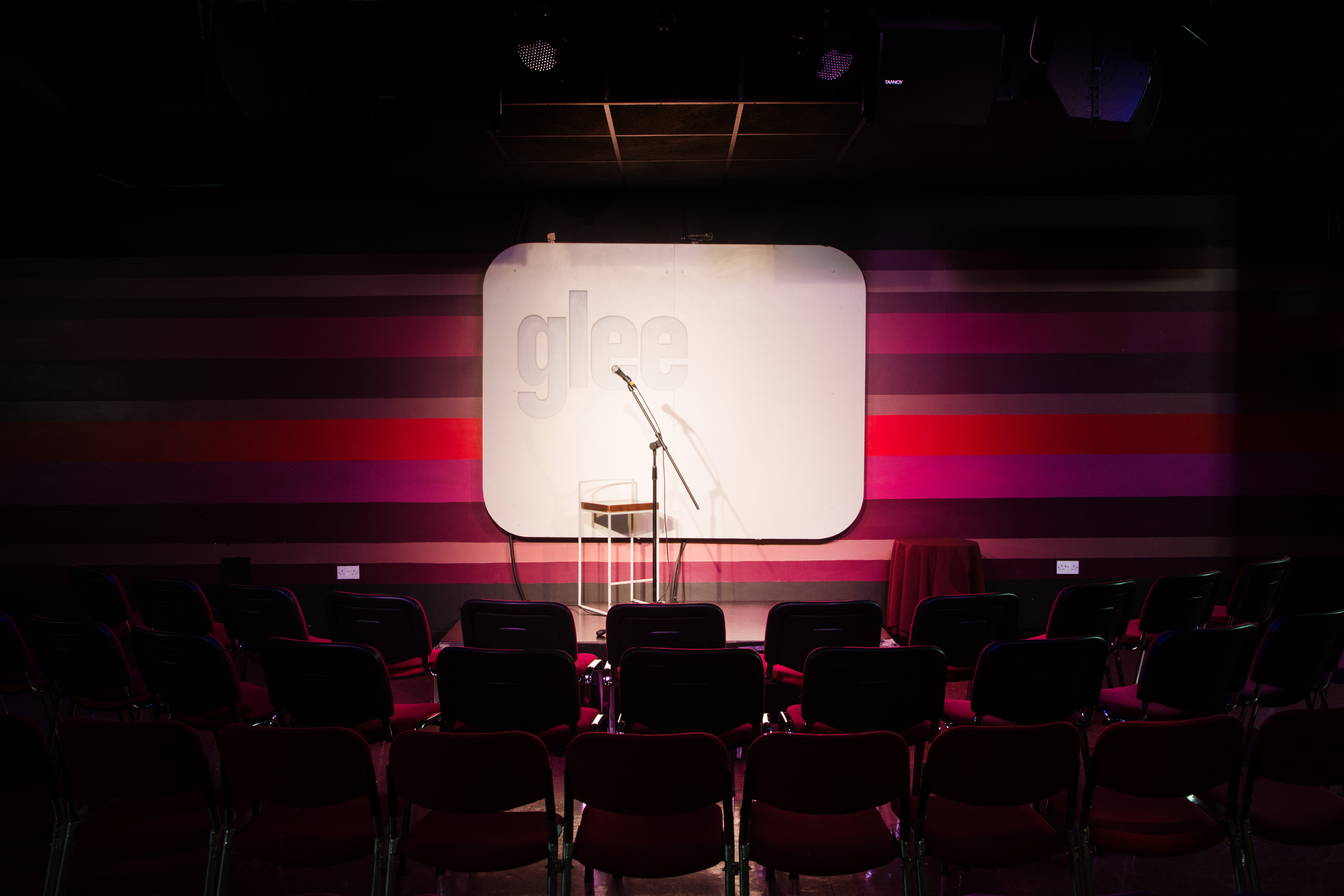 Intimate stage setup with microphone for presentations in Glee Club Birmingham.