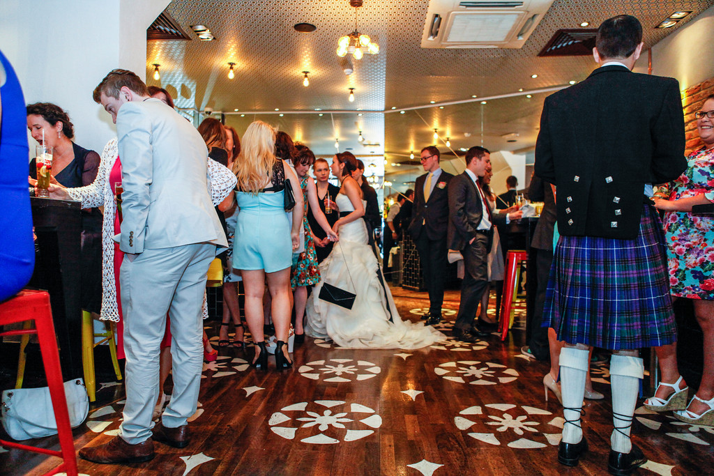 Lively wedding reception at Whole Venue, stylish decor, mingling guests in formal attire.