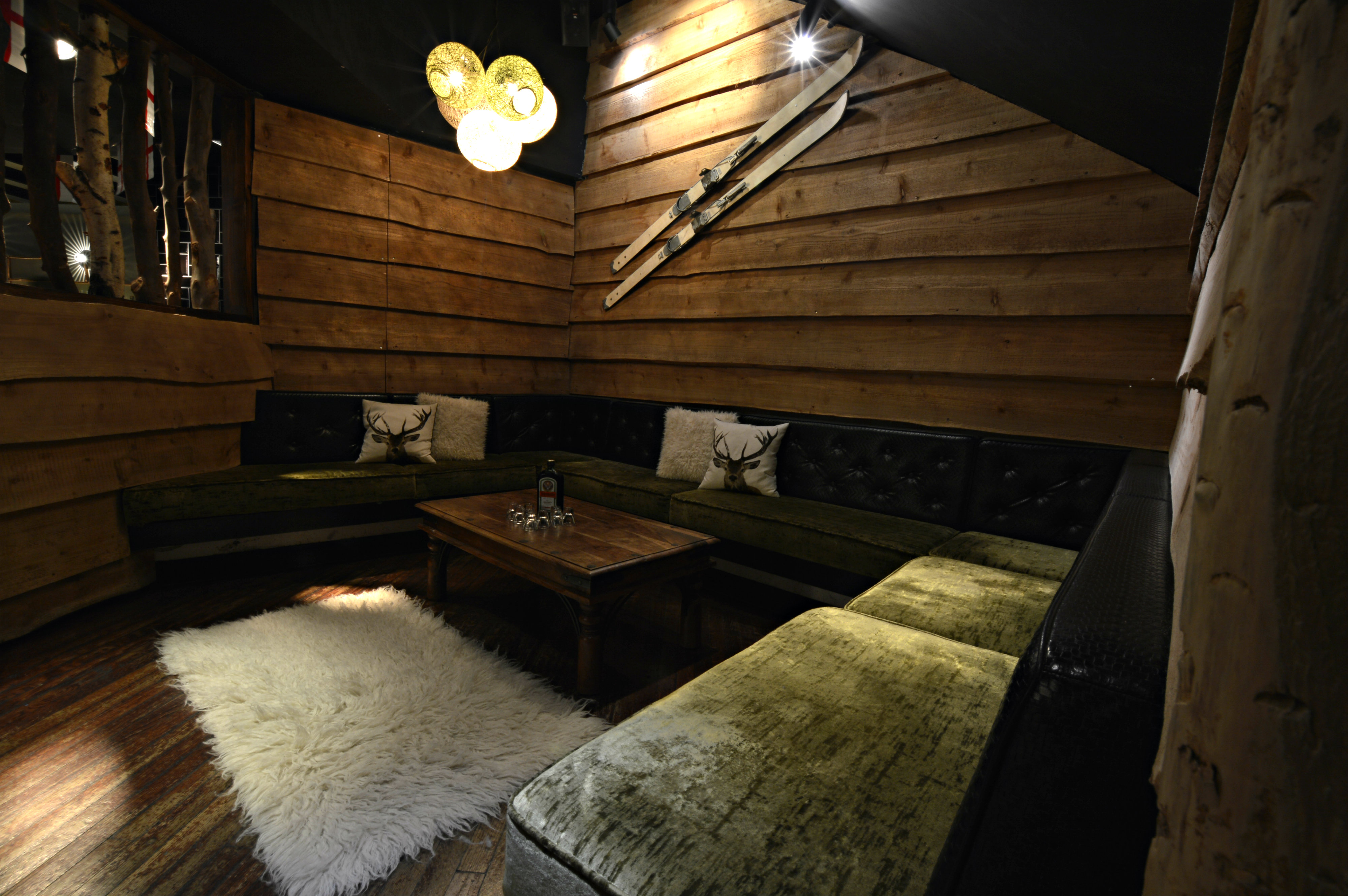 Cozy meeting space with warm wood and plush seating, ideal for group discussions.