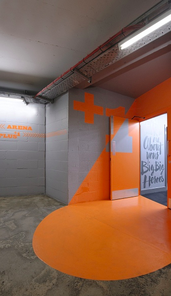 Vibrant event space entrance with orange accents at Manchester Arena for dynamic meetings.