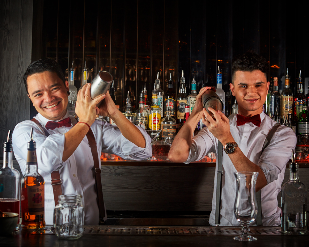"Expert bartenders mix cocktails at Fire Bar, ICE BAR London – ideal for upscale events."