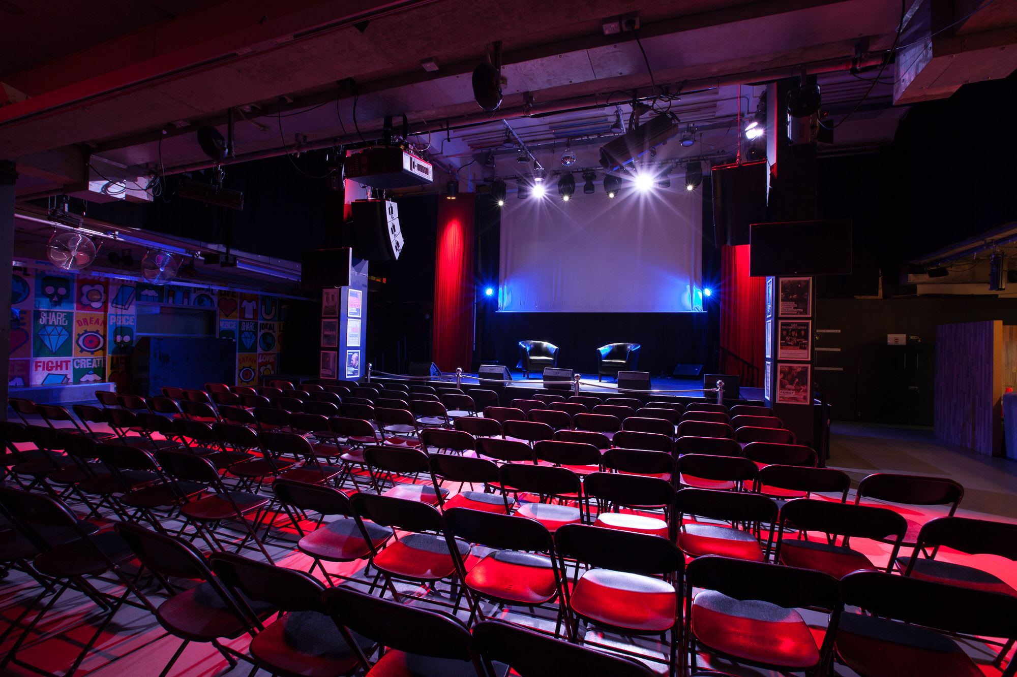 Event space at Rich Mix with stage, lighting, and seating for presentations and performances.