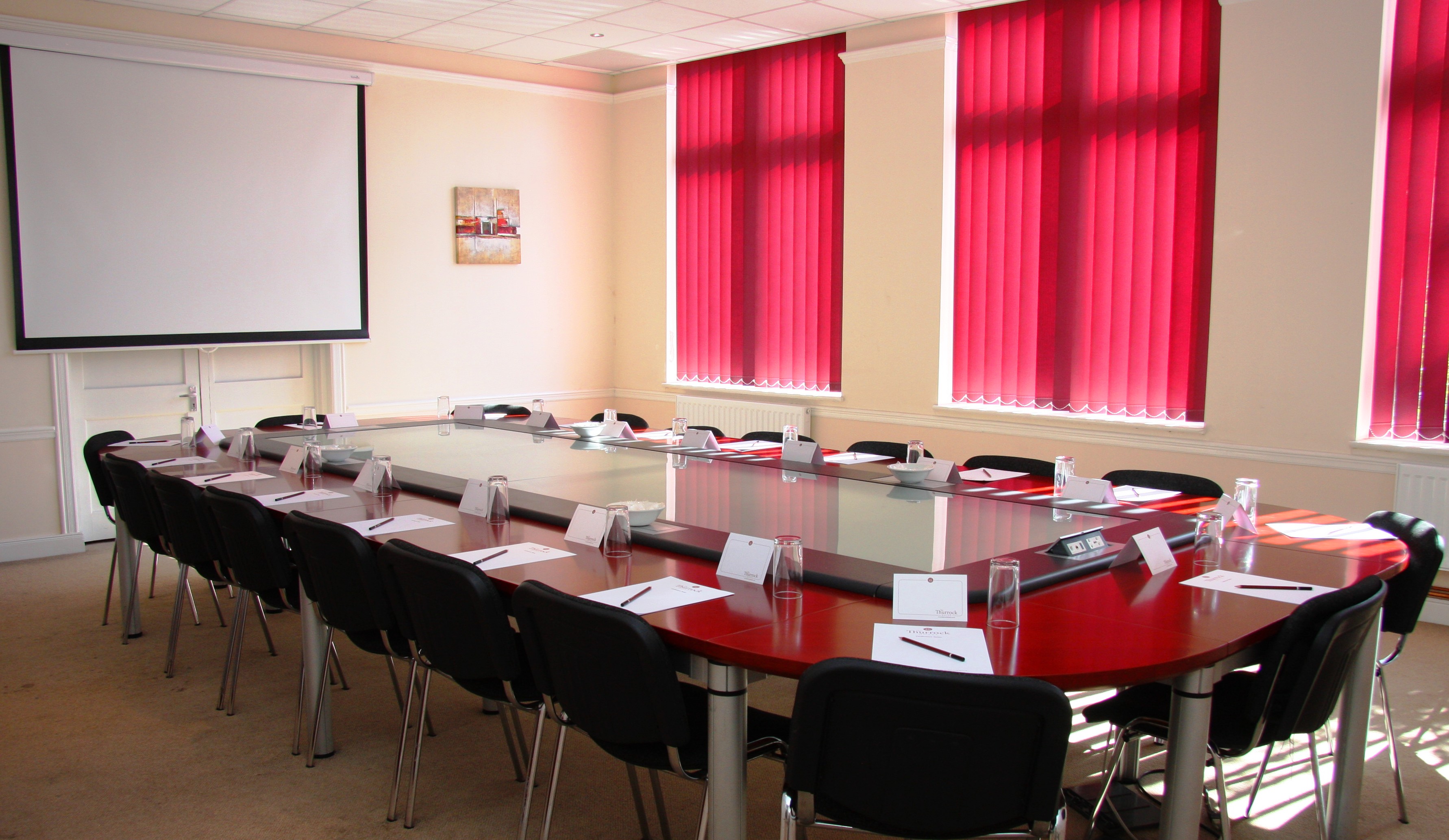 Aveley meeting room with large table, ideal for professional events and presentations.