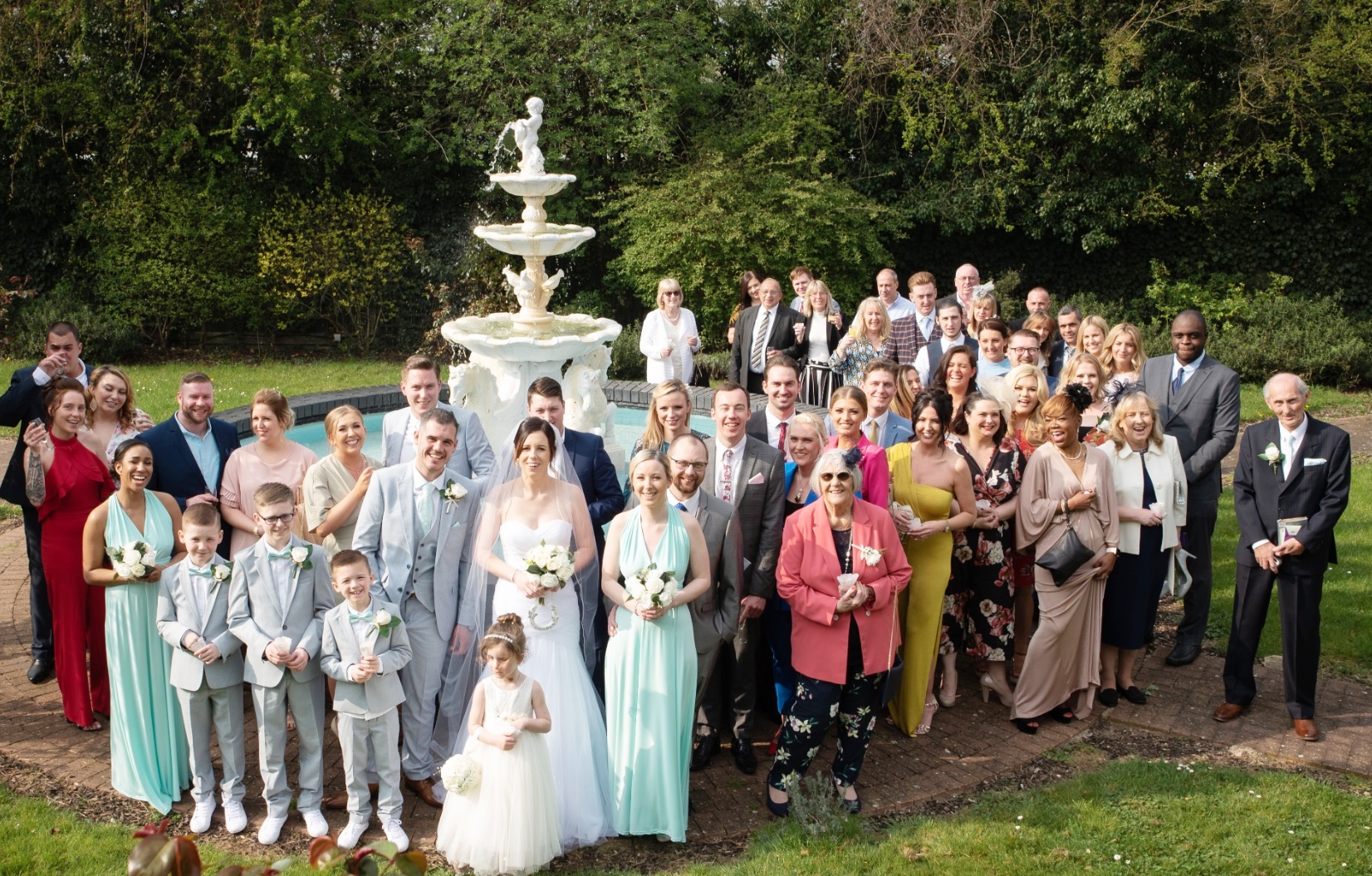 Outdoor wedding gathering at Best Western Thurrock Hotel with elegant fountain.