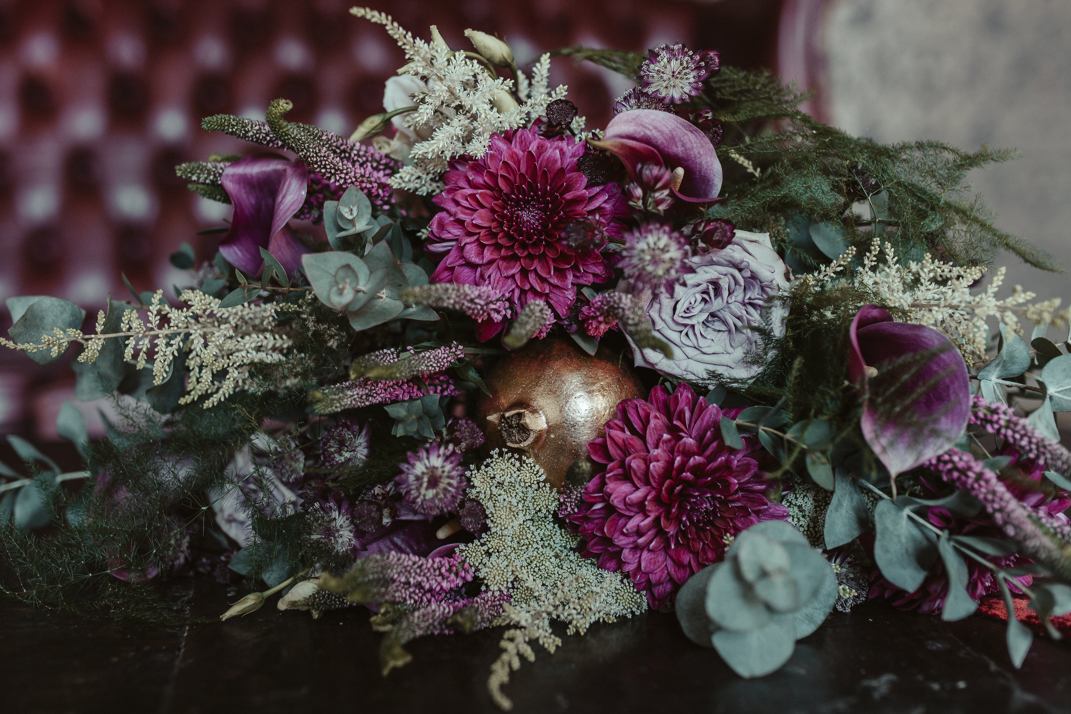 Floral arrangement in purples and greens for upscale weddings and corporate events.