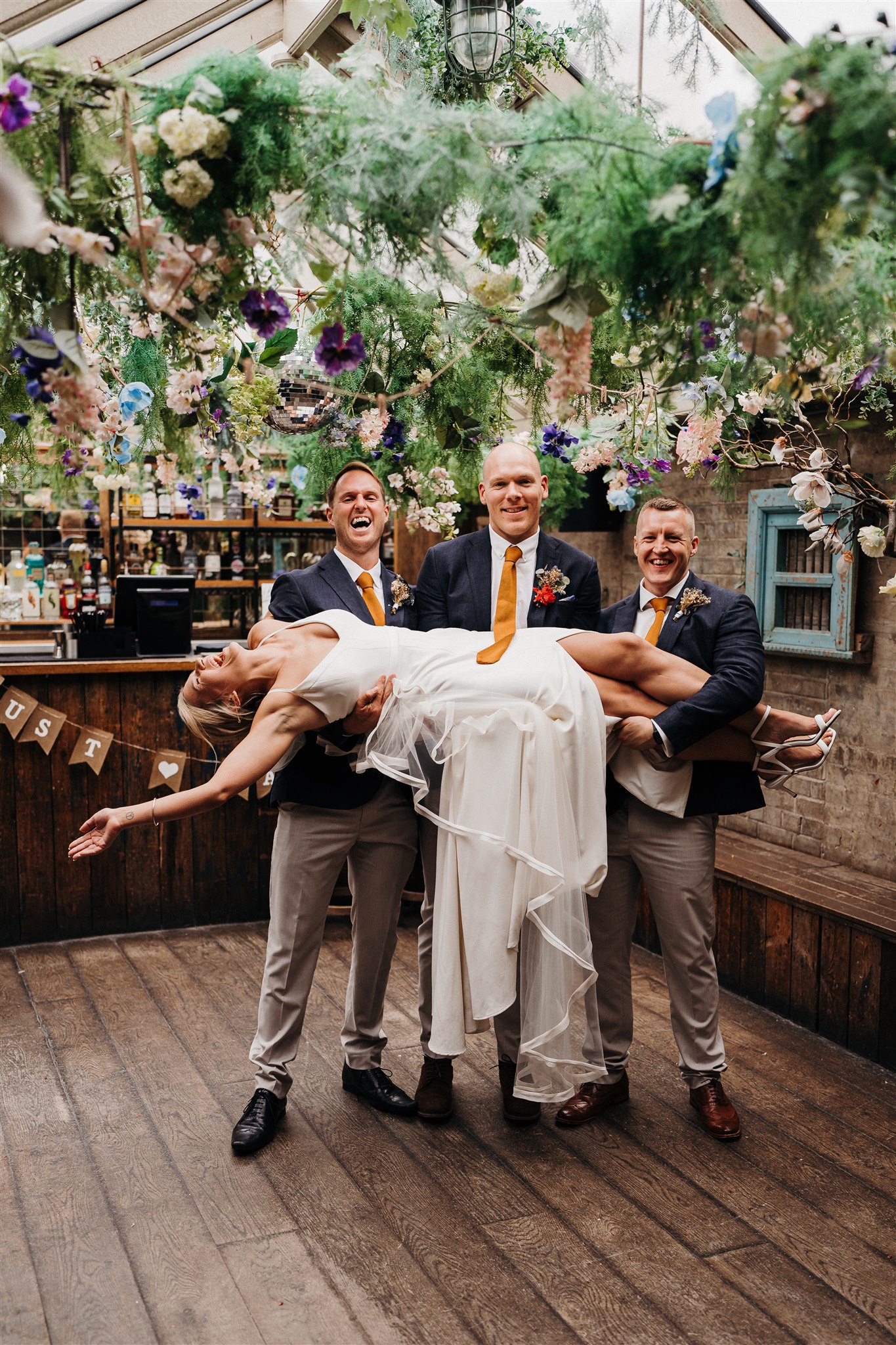 Joyful wedding celebration at Conservatory in Paradise with vibrant floral decor.