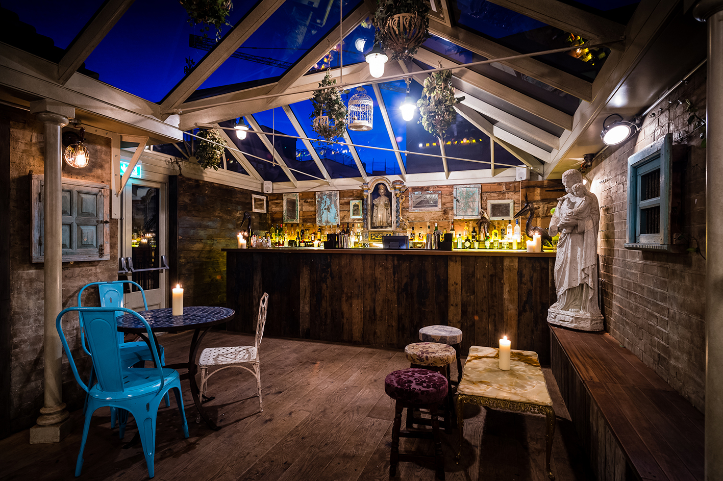 Stylish event space with glass roof, perfect for cocktail receptions and gatherings.