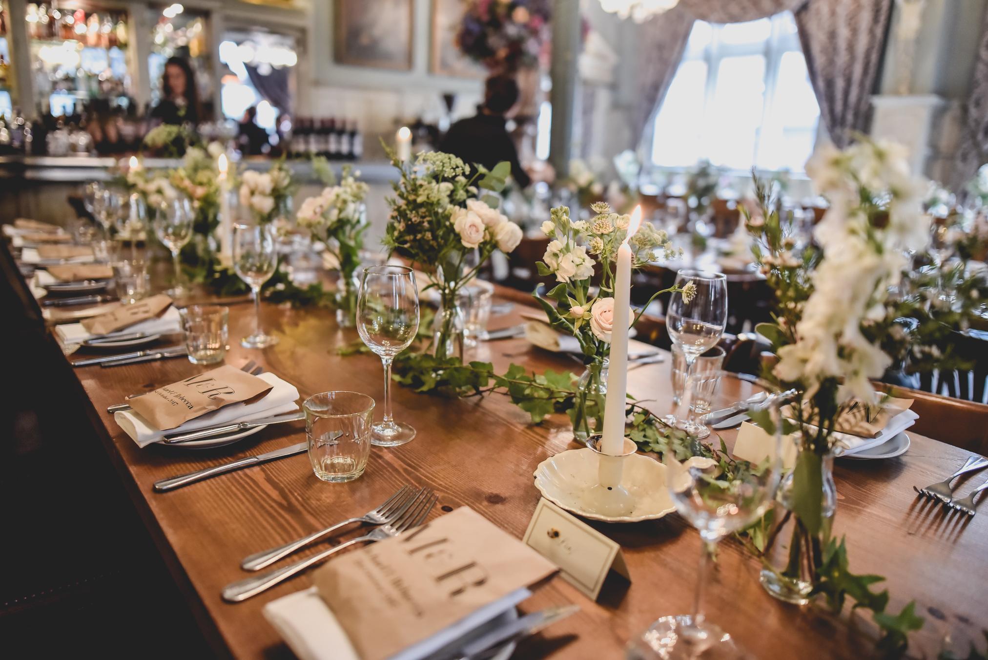 Elegant dining table with floral centerpieces for upscale events in Kensal Green.