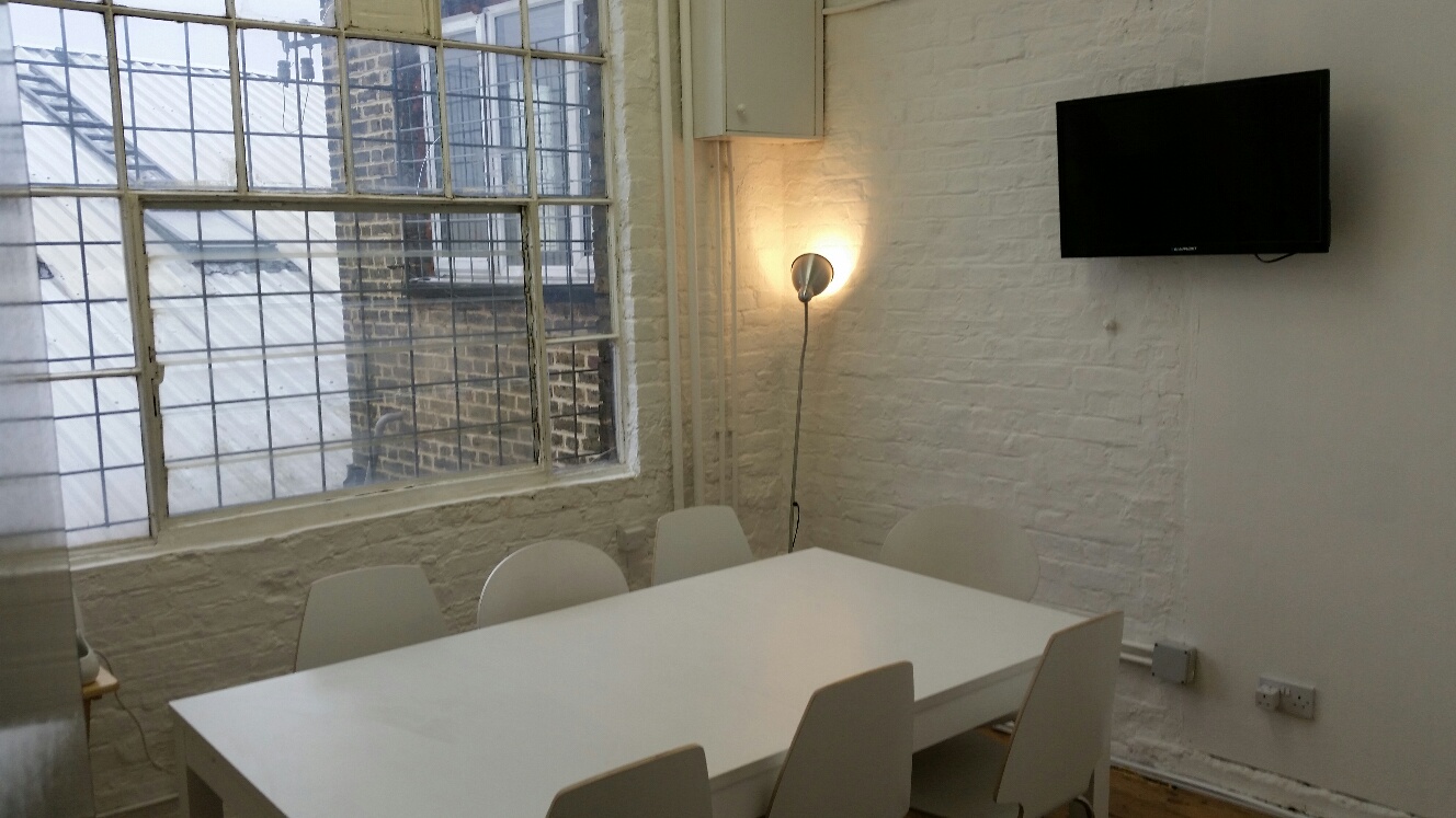 Bright minimalist meeting room at Clapham North Art Centre, perfect for brainstorming sessions.