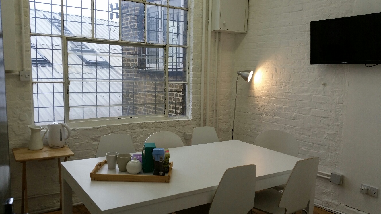 Bright minimalist meeting space at Clapham North Art Centre, ideal for workshops and events.