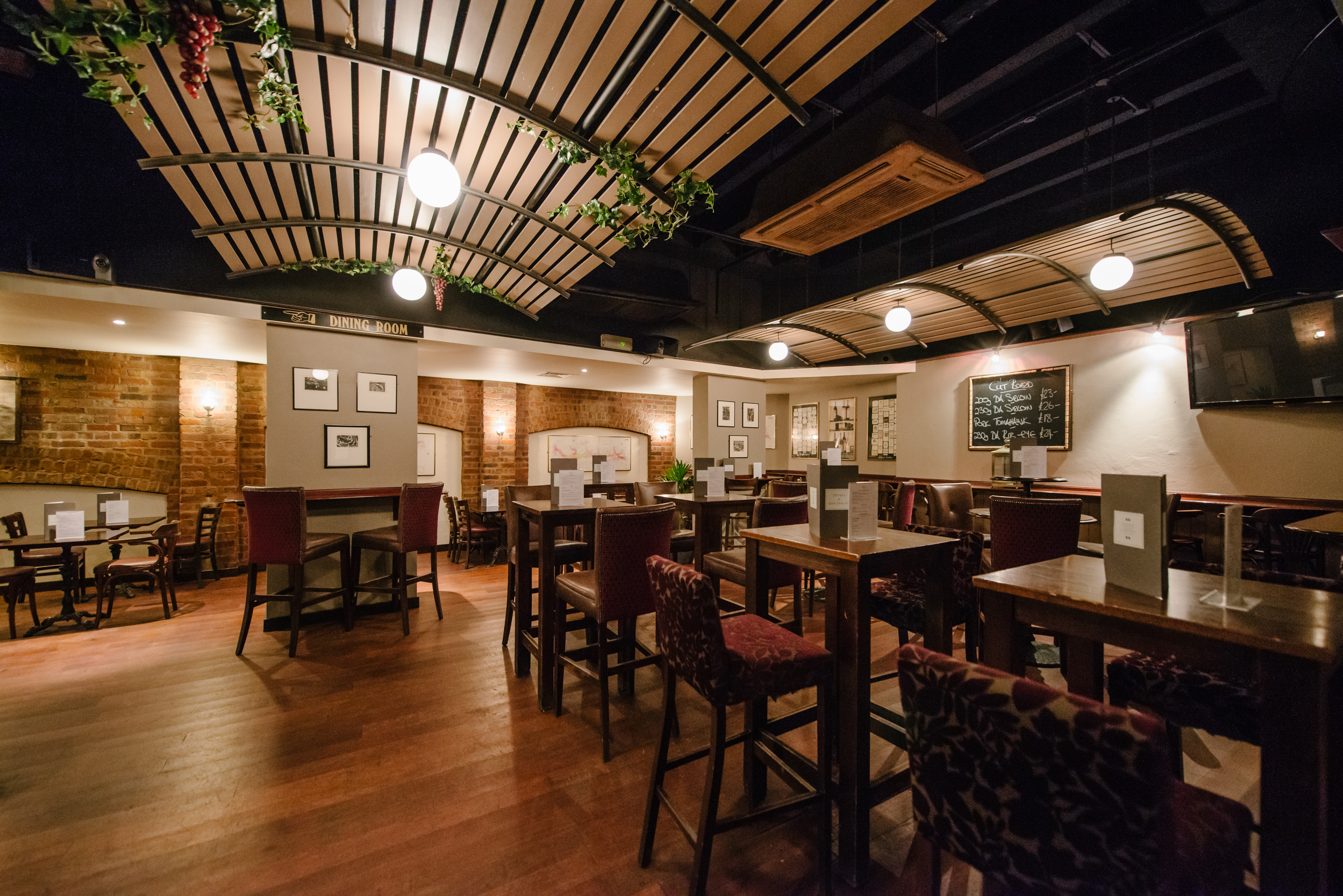 Versatile event space at Willy's Wine Bar with warm ambiance, ideal for gatherings and meetings.