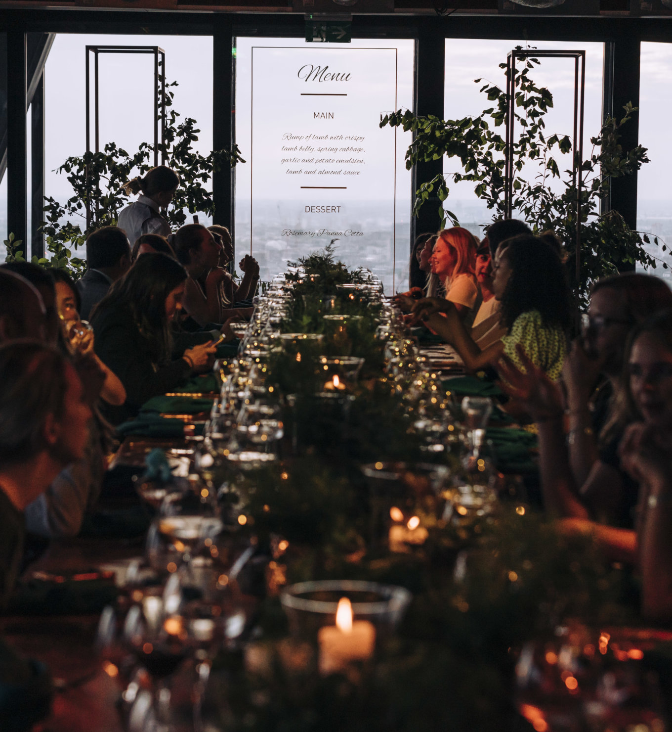Elegant long dining table in lush greenery for intimate event at Leadenhall Building.