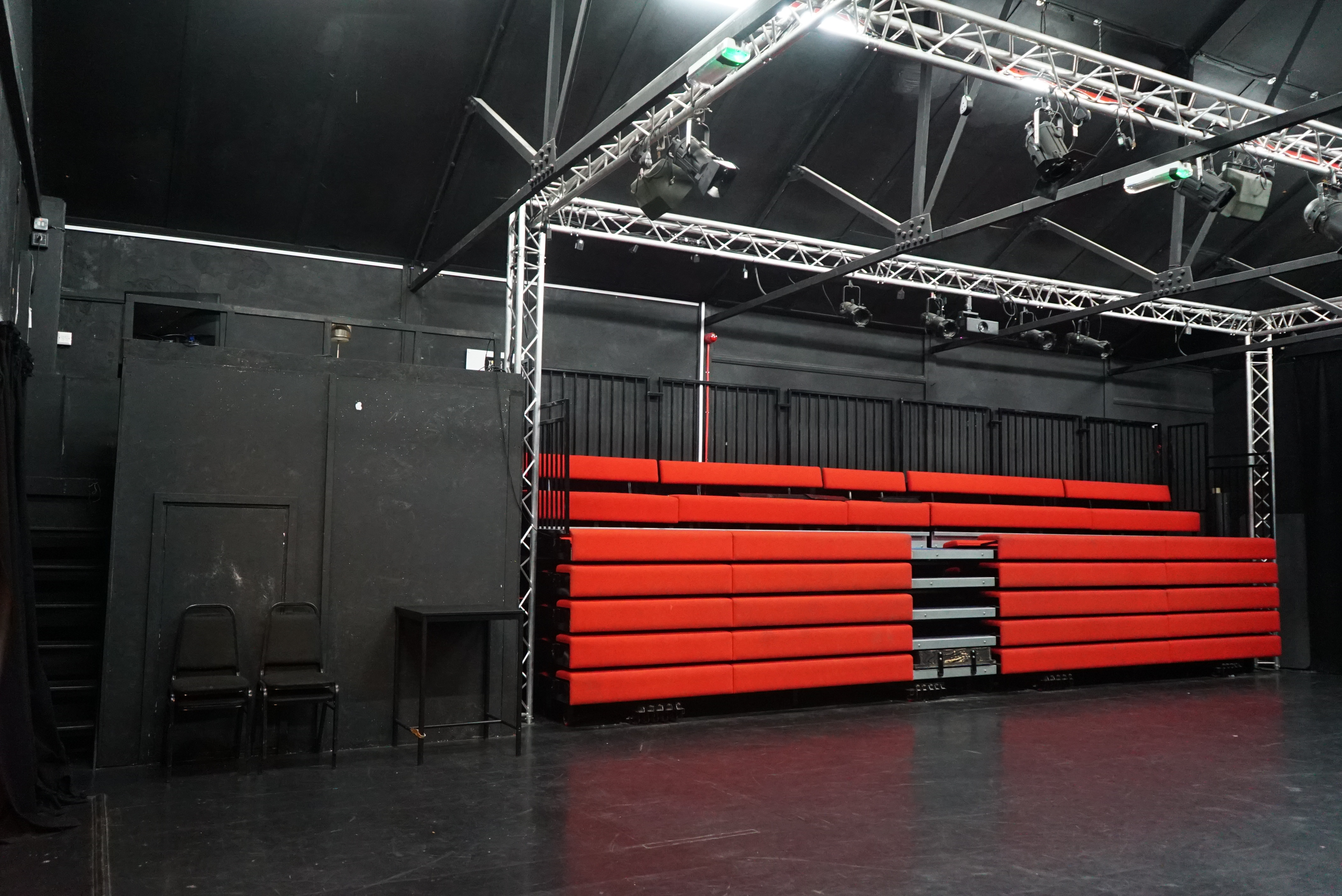 Theatre Space at Young Actors Theatre Islington with tiered red seating for performances.