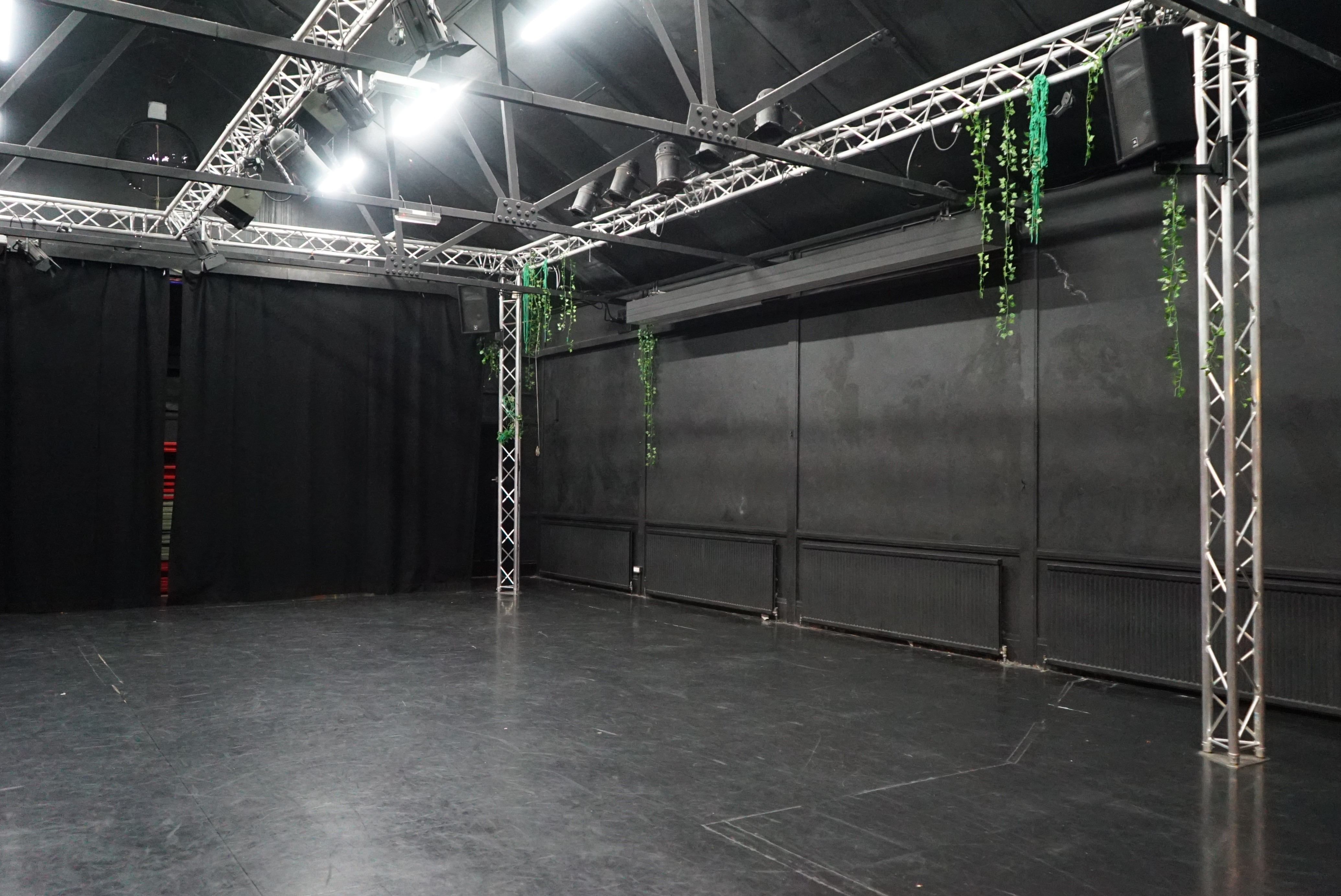 Versatile event space with black backdrop at Young Actors Theatre Islington for performances.