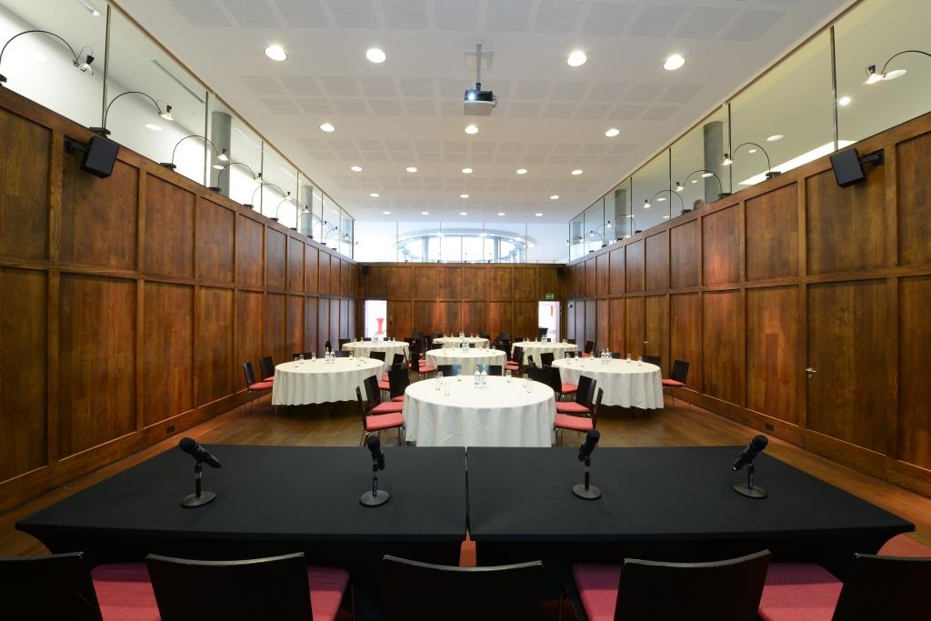 St Martins Hall meeting room with round tables, ideal for events and presentations.