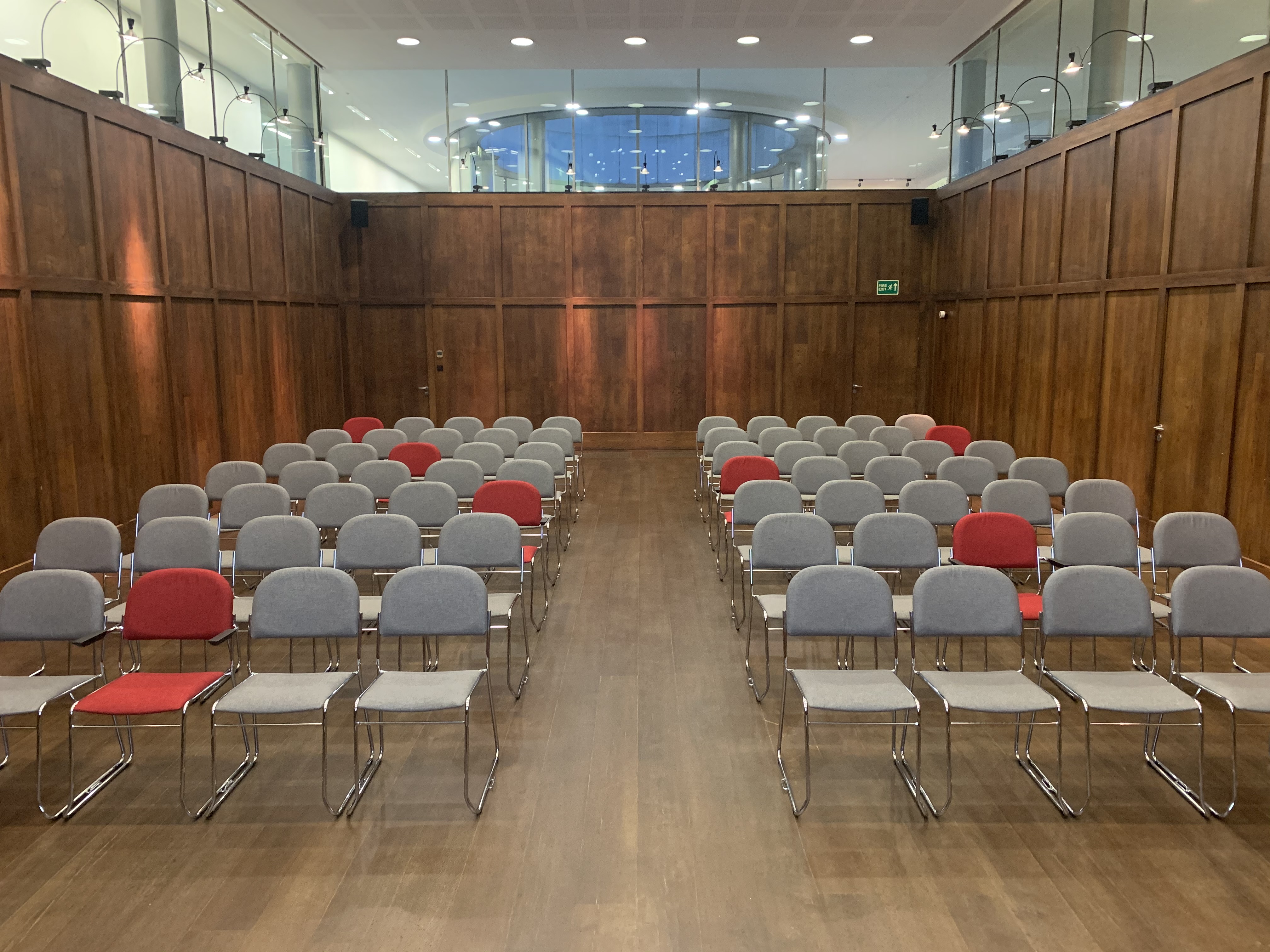 St Martins Hall meeting space with gray and red chairs, ideal for workshops and presentations.