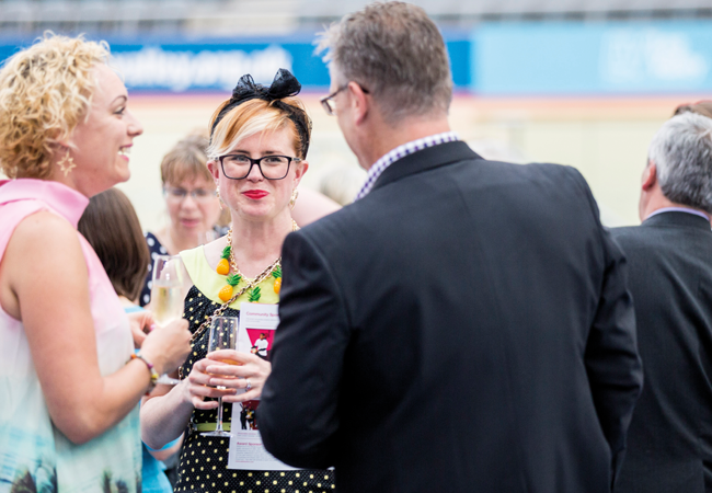 Networking event at Lee Valley VeloPark with diverse professionals in stylish attire.