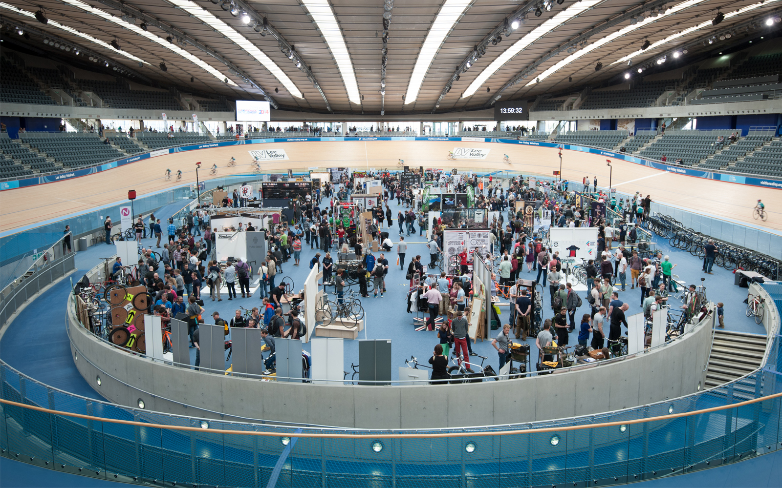Velodrome Track Centre at Lee Valley VeloPark, bustling trade show with interactive booths.