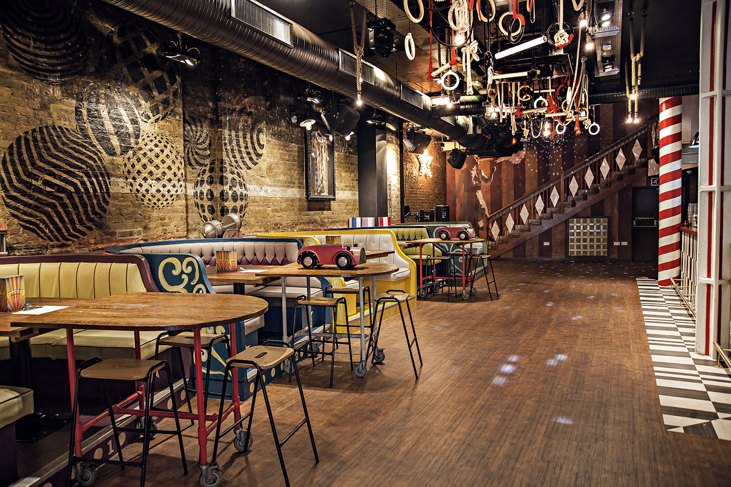 Vibrant Trapeze Bar main event space with colorful seating for gatherings and meetings.