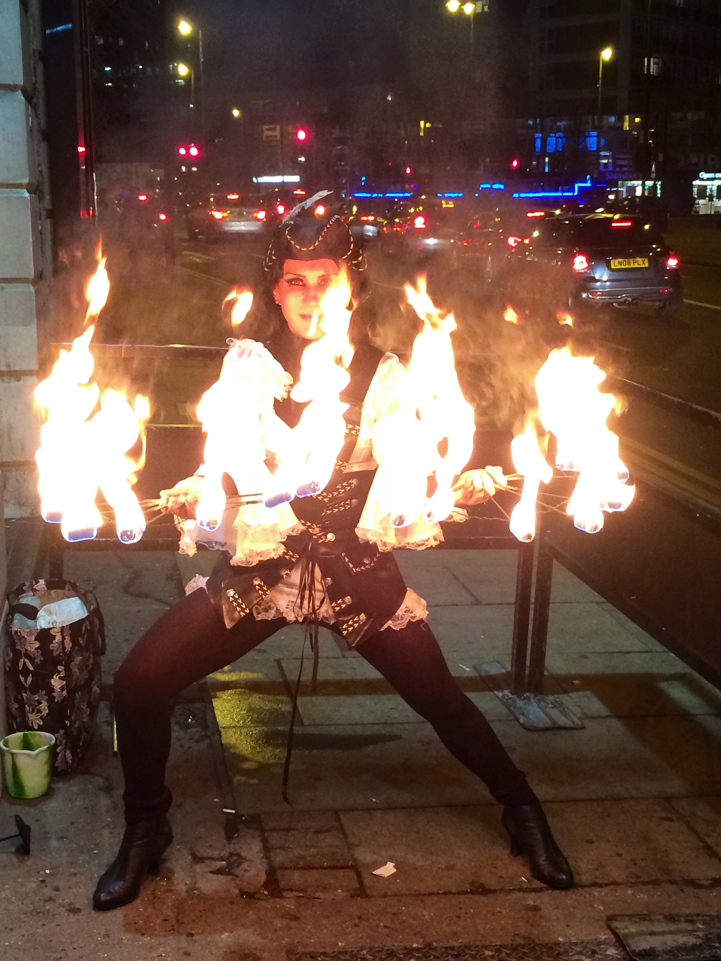 Captivating fire performer at Trapeze Bar for outdoor themed parties and festivals.