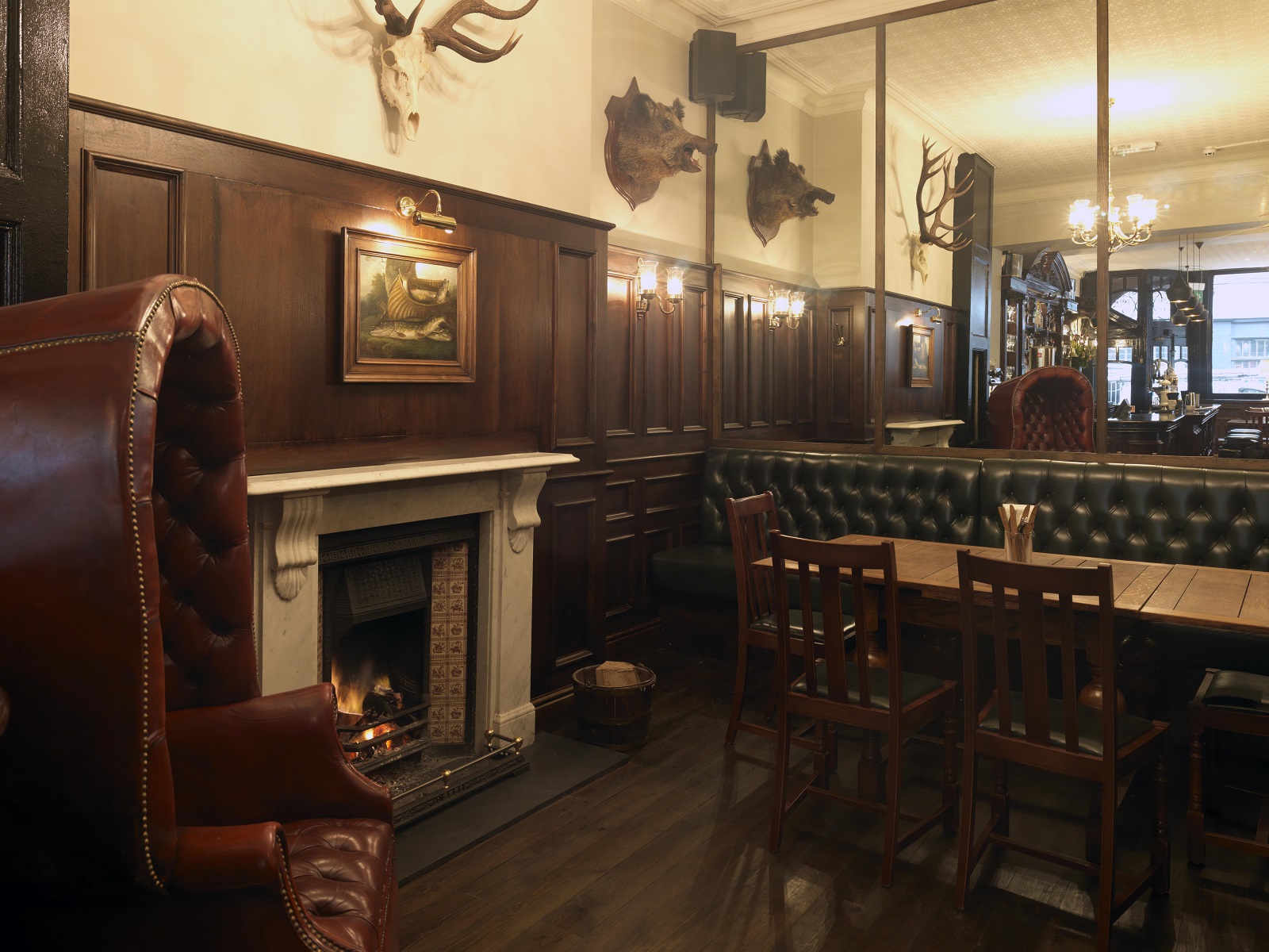 Cozy rustic venue with wood paneling for intimate meetings and small events.