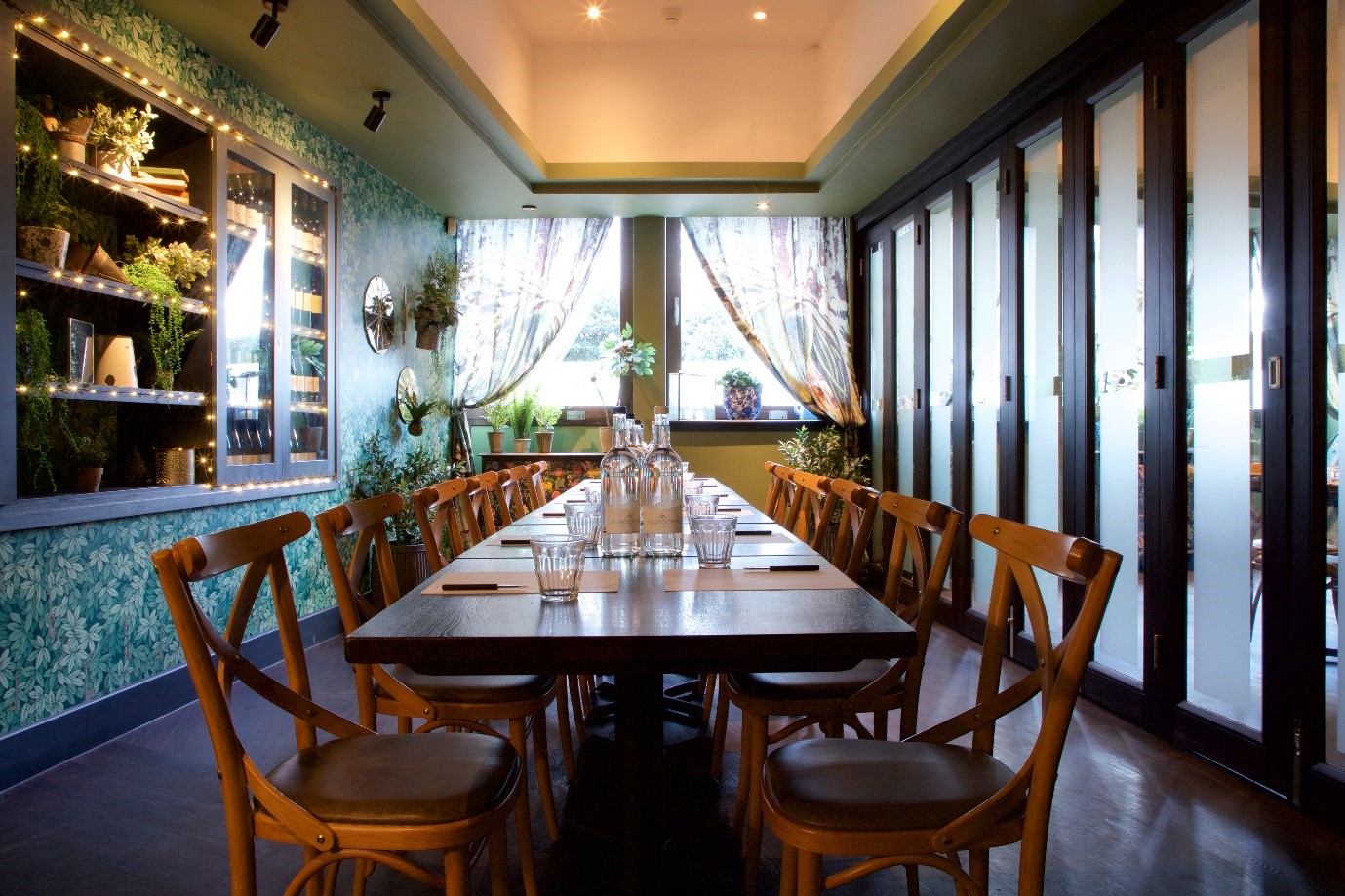 Small private dining room with long table, perfect for workshops and team meetings.