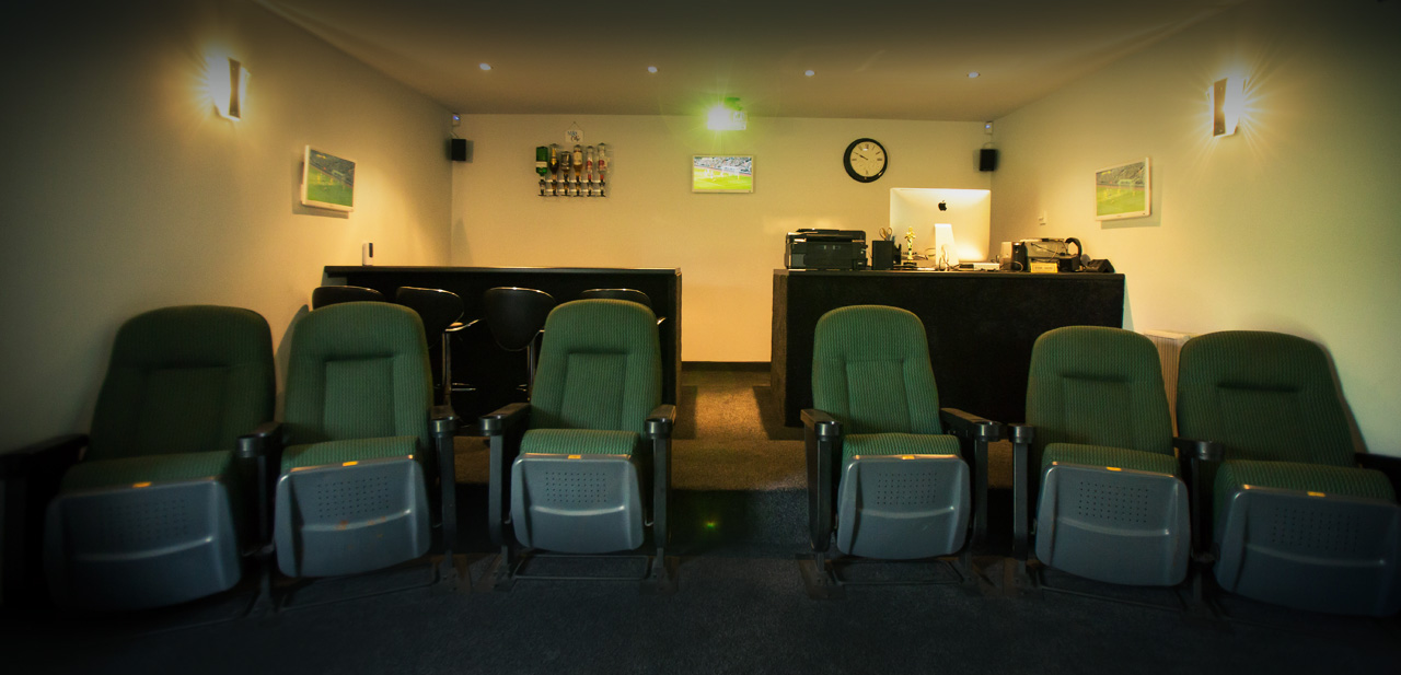 Cozy meeting space at Elysion Cinemas with green seating for small gatherings.