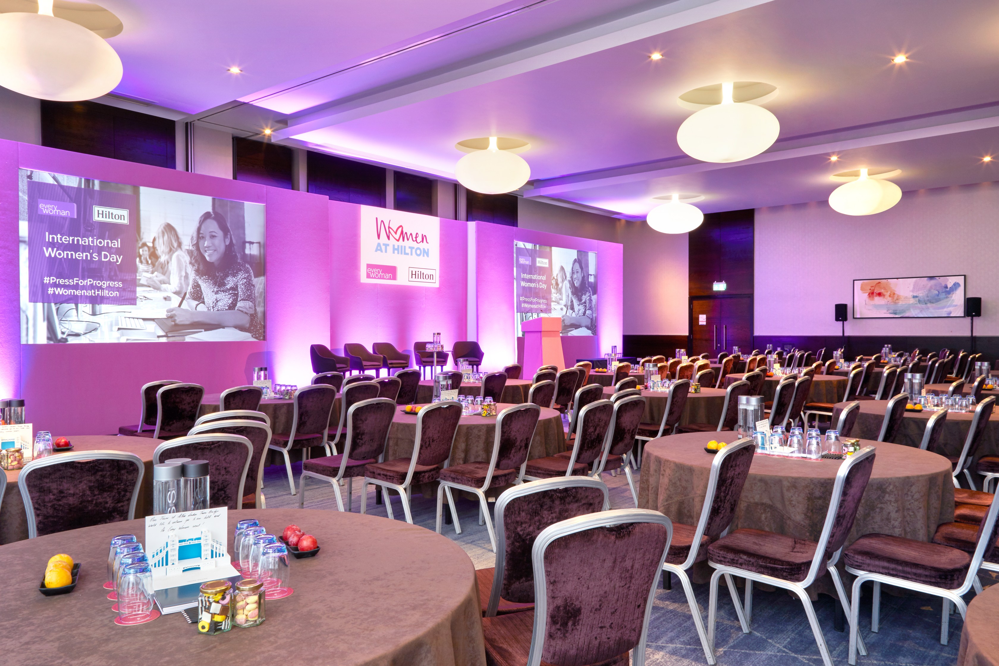 Tower Suite conference setup with round tables for International Women’s Day event.