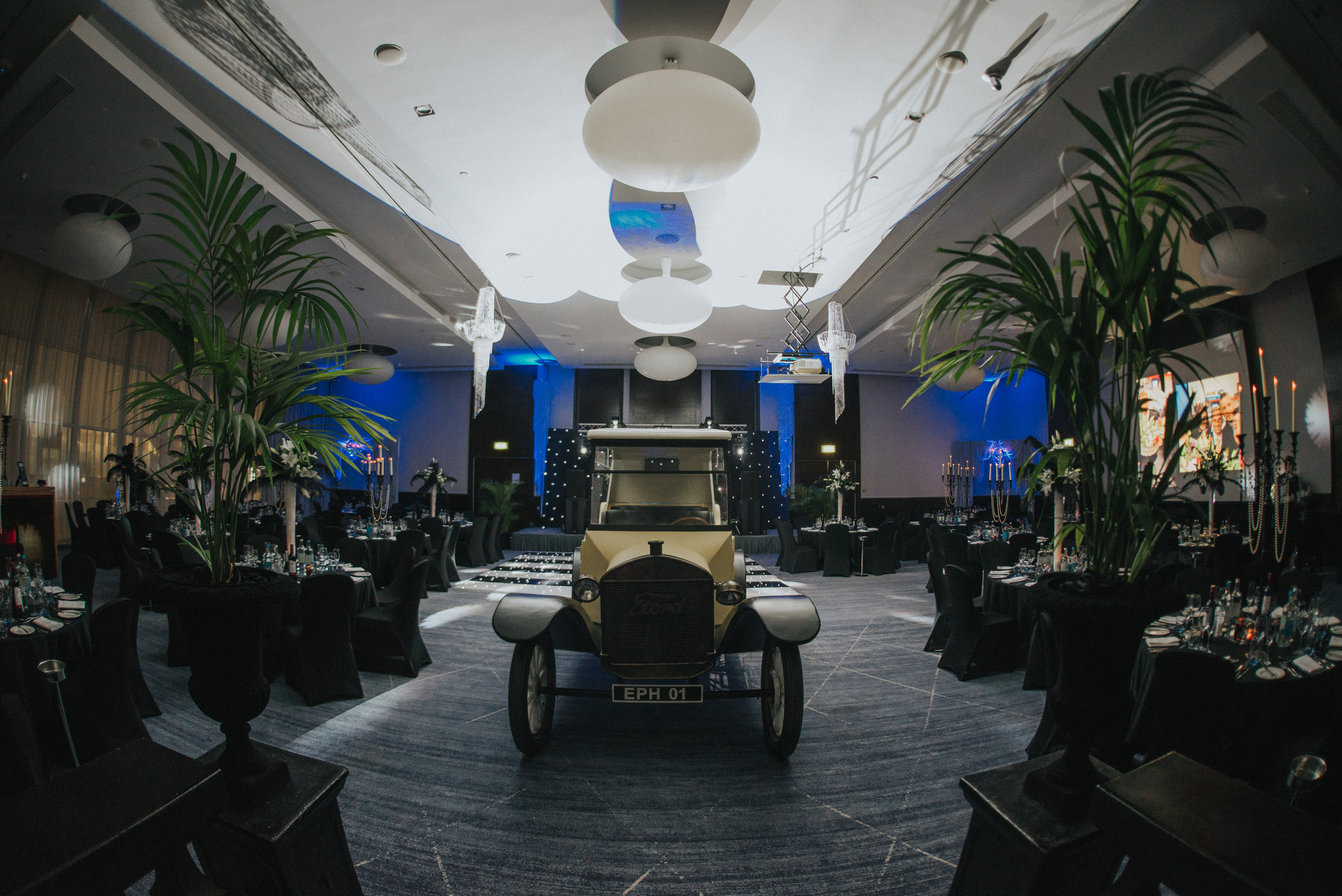 Tower Suite at Hilton London Tower Bridge with vintage car centerpiece for corporate events.
