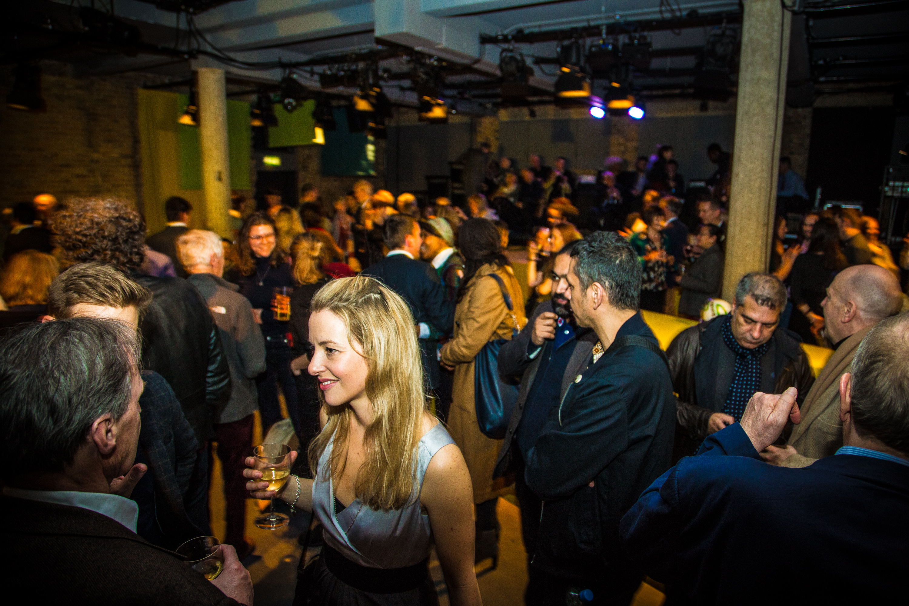 Vibrant networking event in Bush Theatre auditorium with engaged attendees and inviting ambiance.