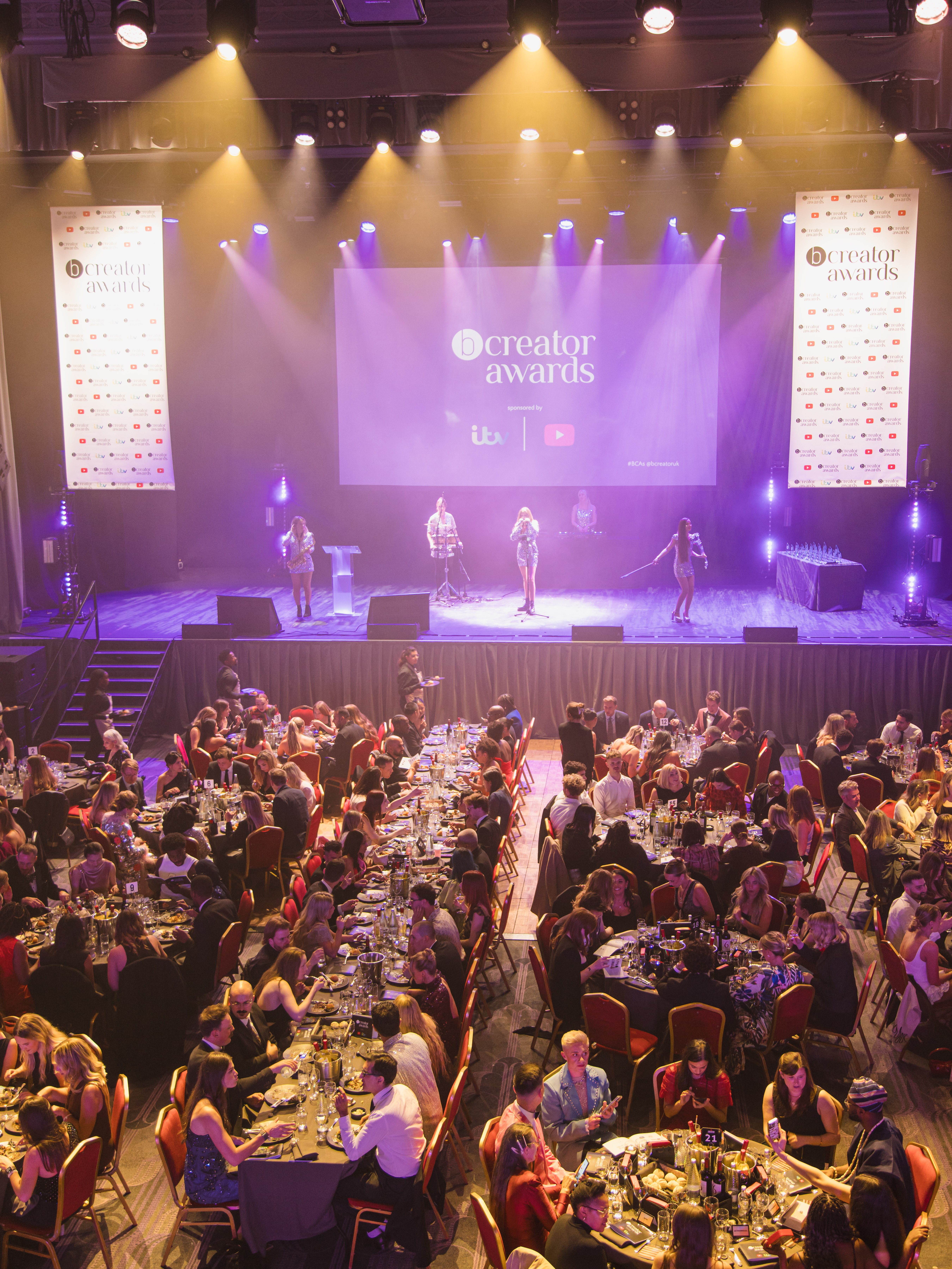 Vibrant awards ceremony in The Grand Hall, Troxy with elegant tables and performers.