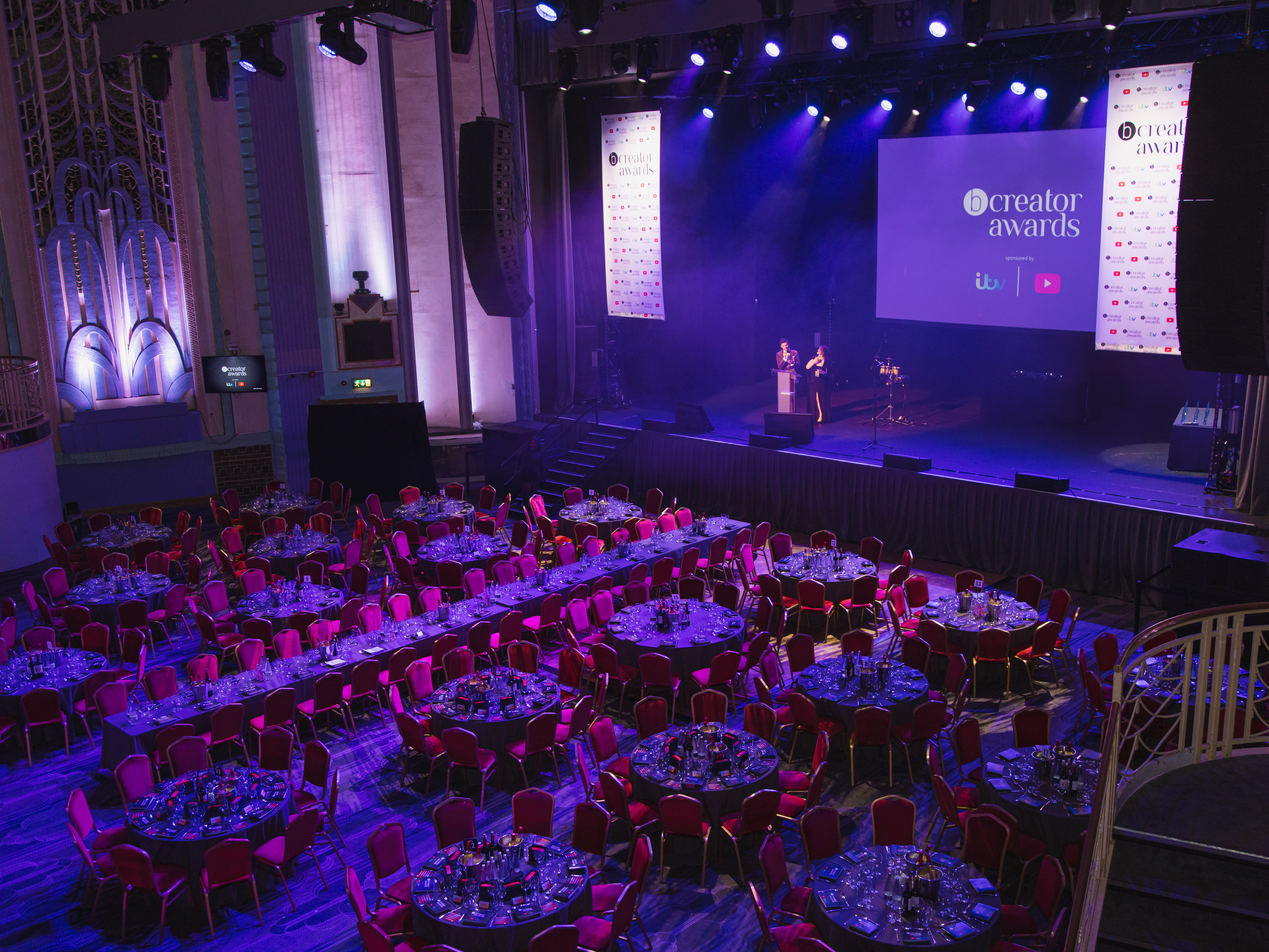 Elegant Grand Hall in Troxy set for a formal awards ceremony with round tables.