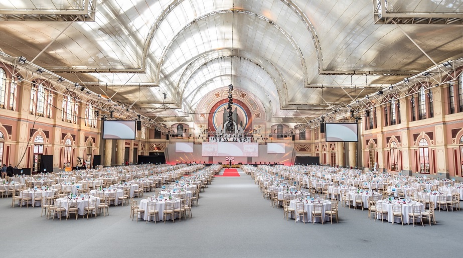 Great Hall at Alexandra Palace set for a grand banquet with elegant round tables.